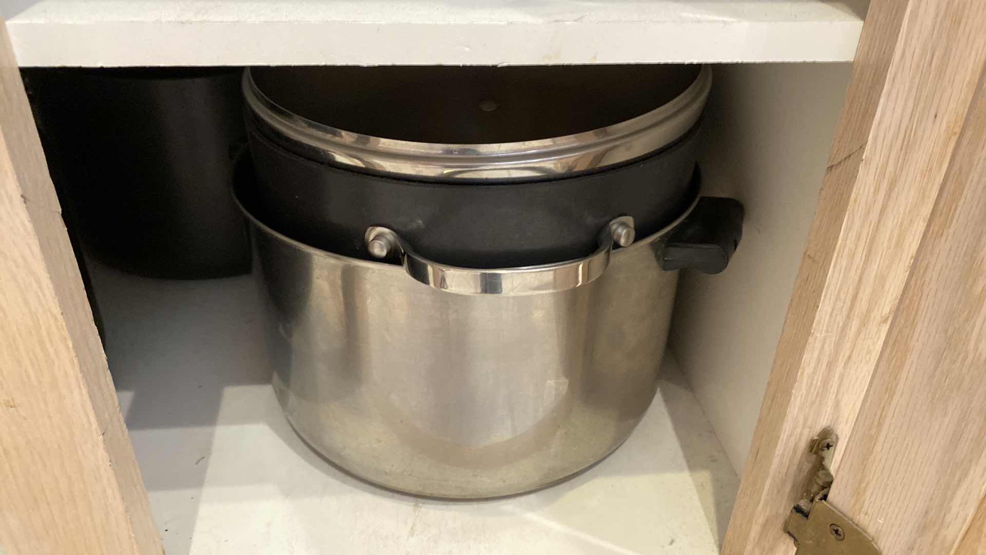 Photo 1 of CONTENTS OF KITCHEN CABINET POTS AND PANS