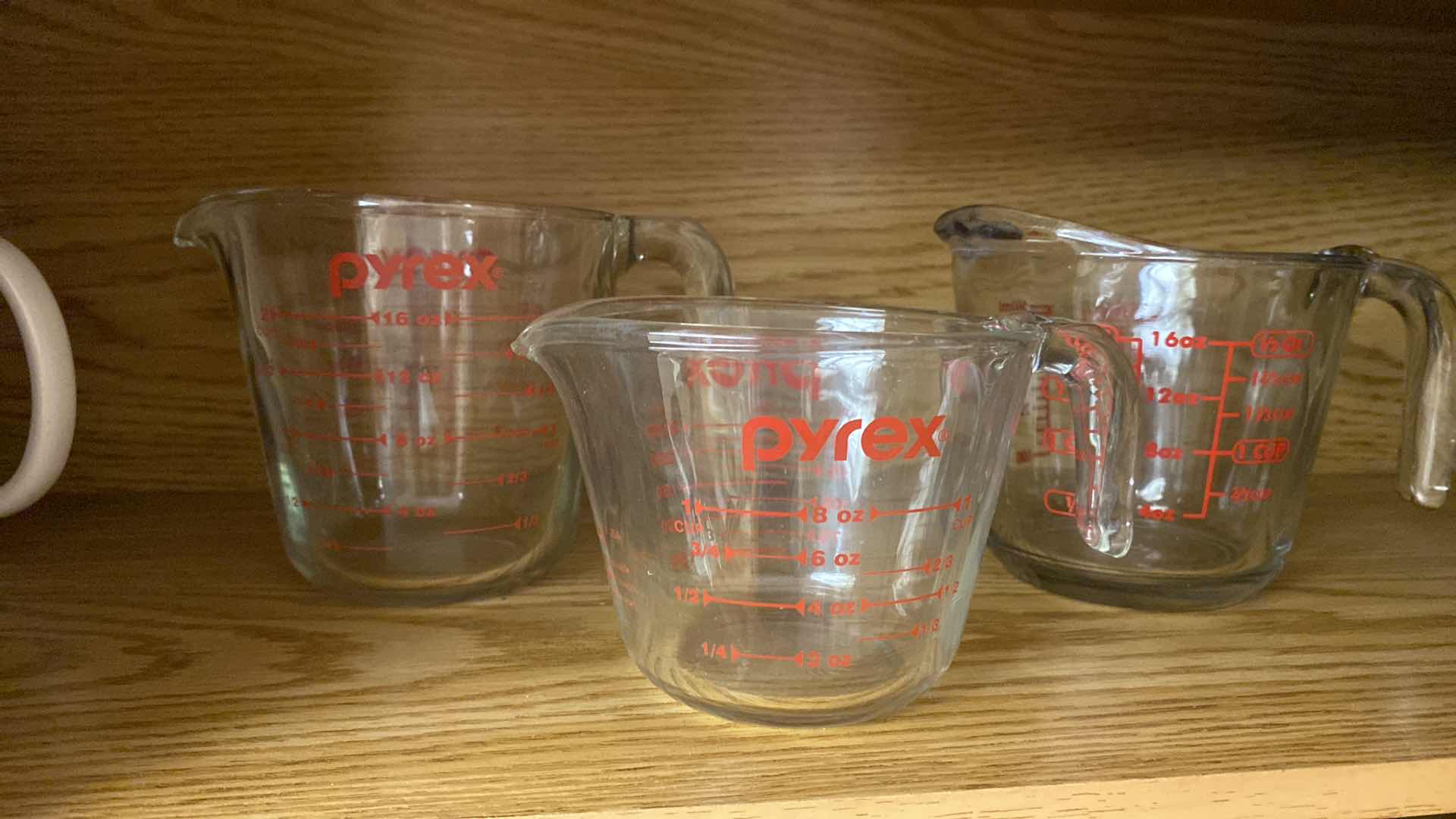 Photo 3 of CONTENTS OF KITCHEN CABINET PYREX MEASURING CUPS AND MORE