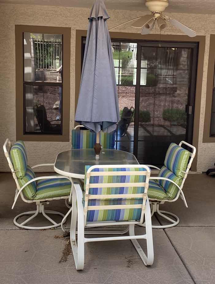 Photo 1 of ALUMINUM PATIO TABLE  54“ x 35“ H 27 1/2 “WITH GLASS TOP AND 4 CHAIRS AND UMBRELLA