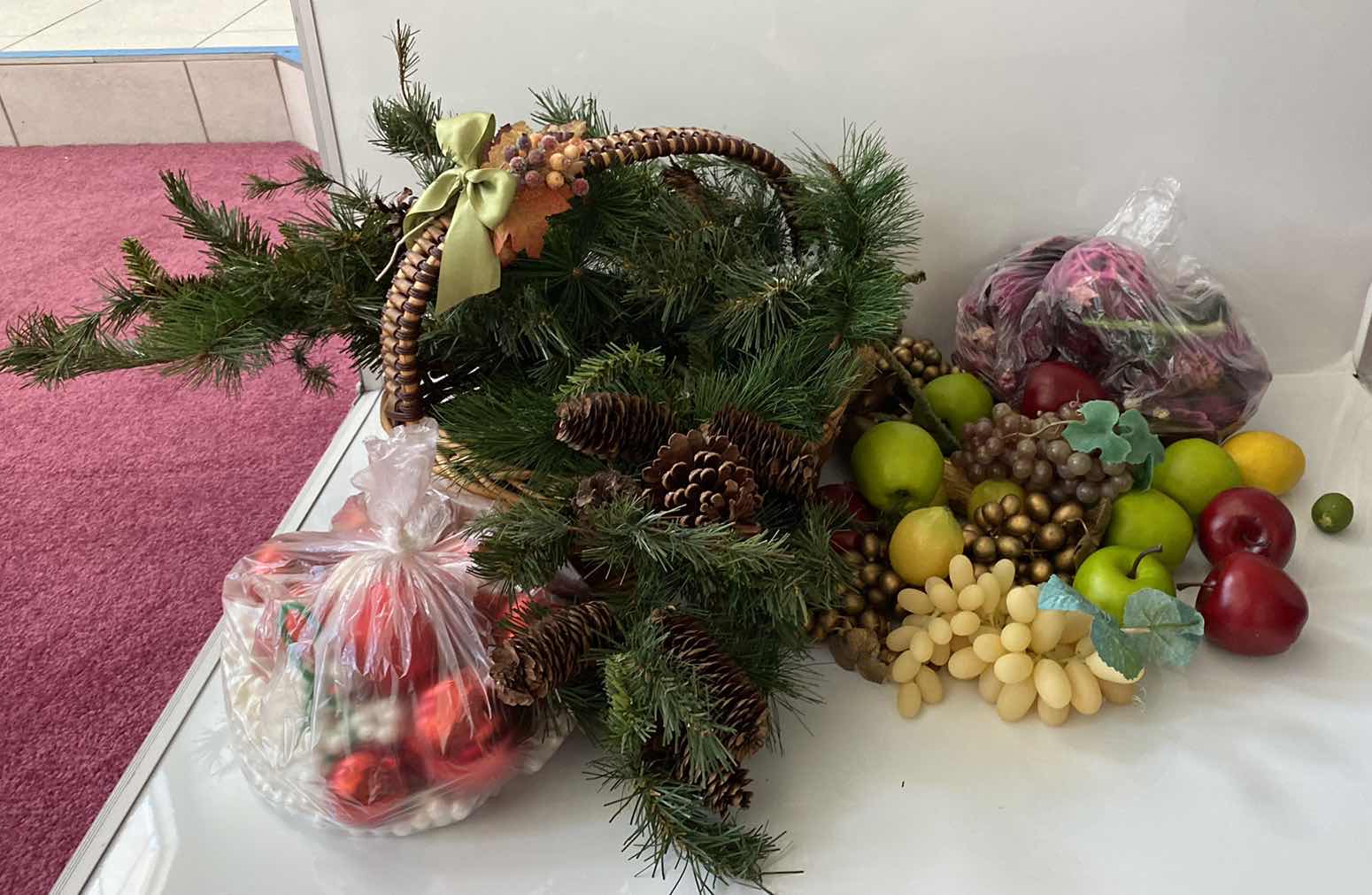 Photo 1 of FAUX FRUIT AND BASKET WITH PINE BRANCHES AND RED HOLIDAY BALLS