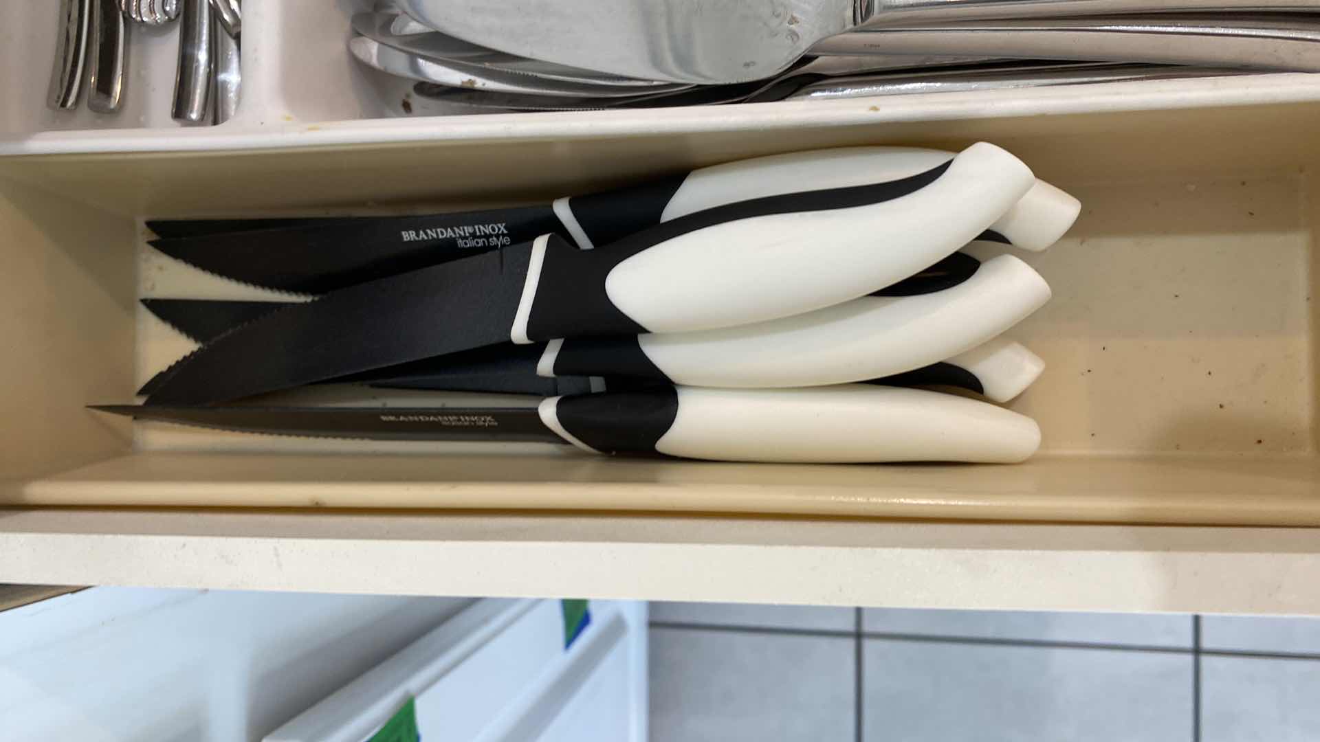 Photo 2 of CONTENTS OF KITCHEN CABINET DRAWER - HENKELS STAINLESS SILVERWARE AND STEAK KNIVES