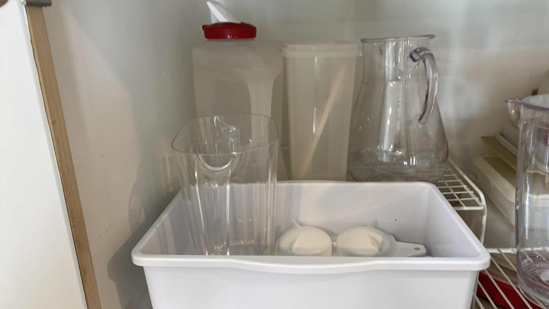 Photo 3 of CONTENTS OF KITCHEN CABINET ABOVE FRIDGE - PLASTIC PITCHERS STORAGE AND SHELVING