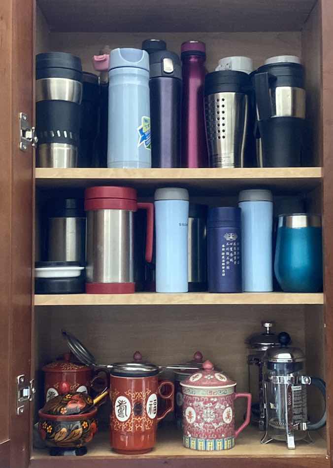 Photo 1 of CONTENTS KITCHEN CABINET- TEA CUPS & INSULATED CUPS