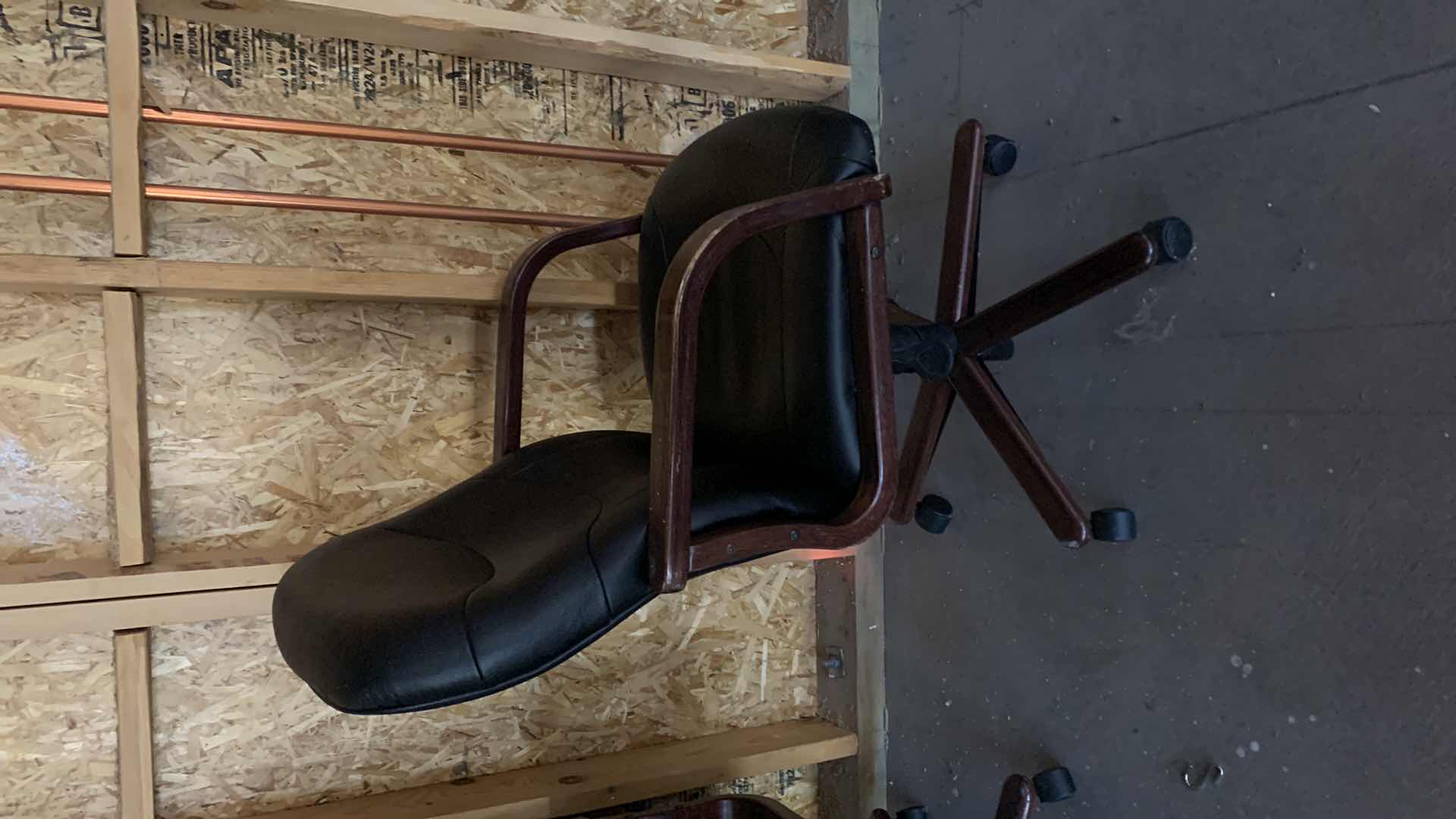 Photo 2 of BLACK WOOD AND BONDED LEATHER OFFICE CHAIR ON WHEELS