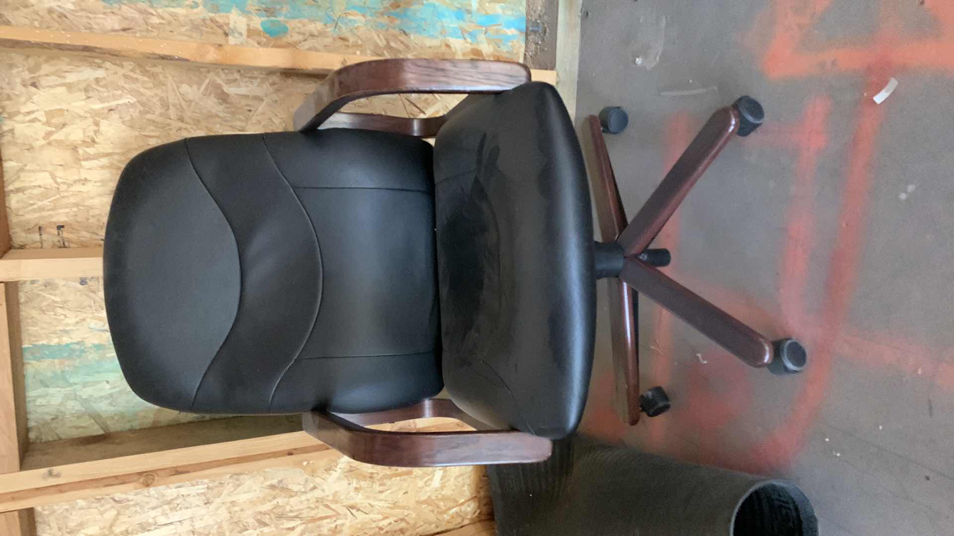 Photo 1 of BLACK WOOD AND BONDED LEATHER OFFICE CHAIR ON WHEELS
