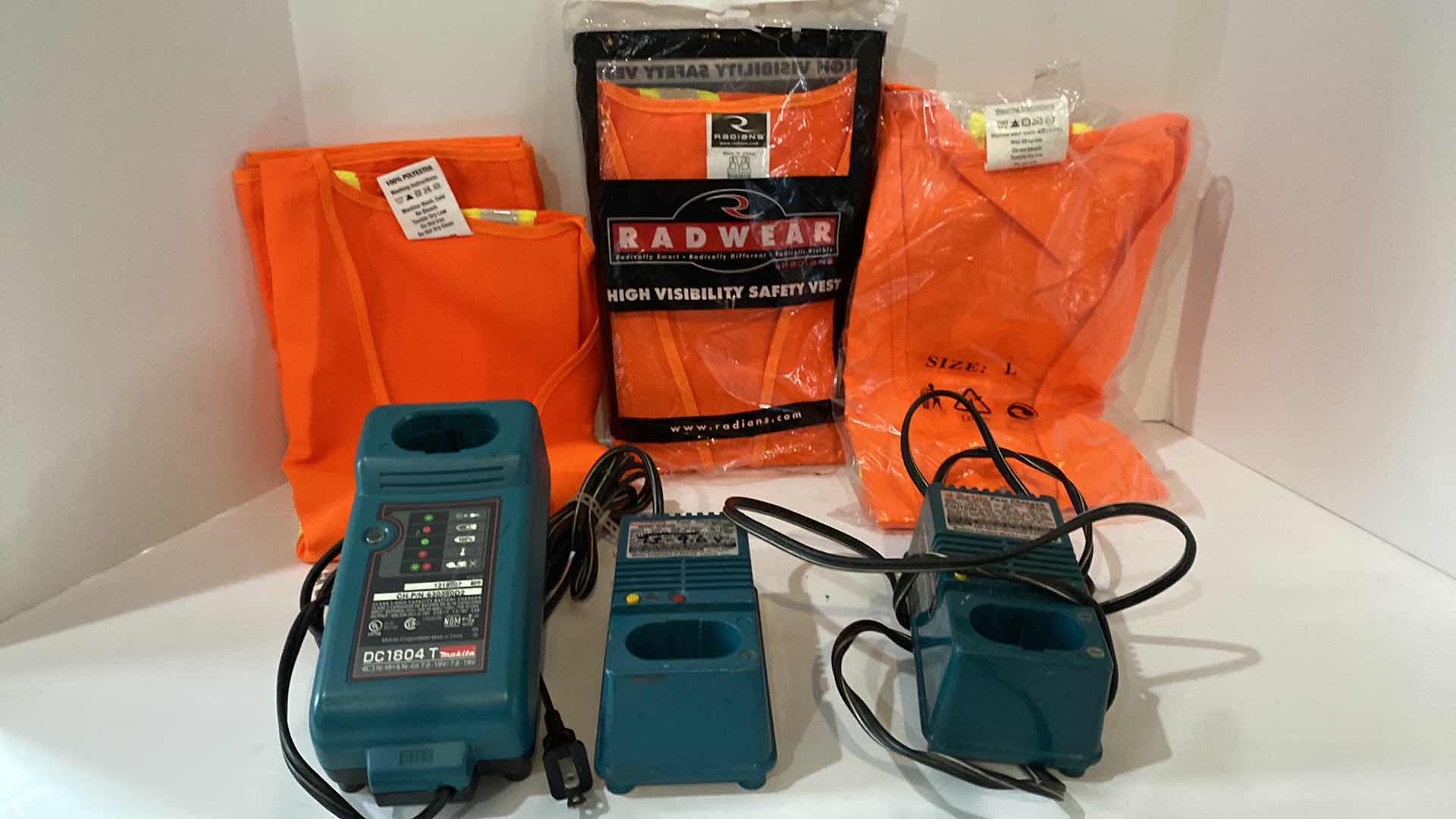 Photo 1 of 3 SAFETY VESTS AND 3 MAKITA BATTERY CHARGERS