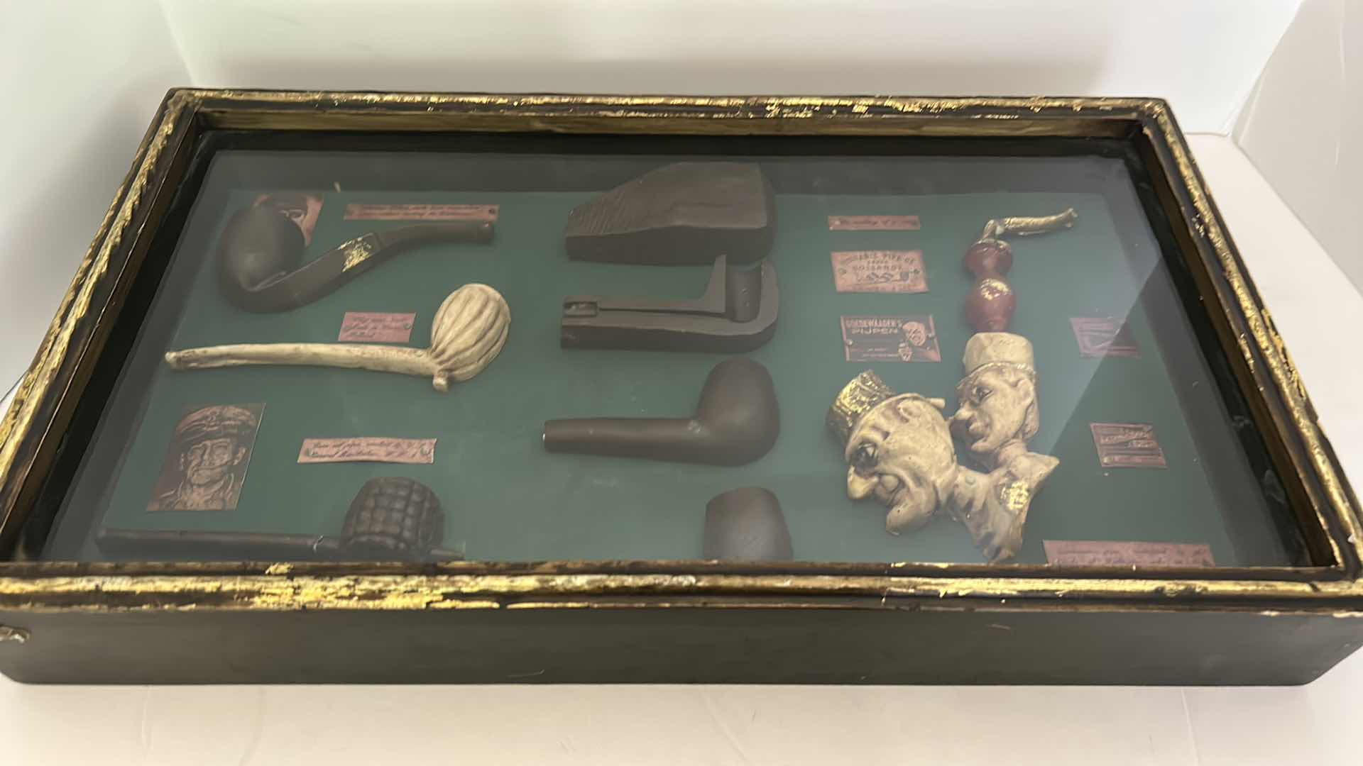 Photo 2 of DISTRESSED BLACK AND GOLD FRAMED SHADOW BOX WITH VINTAGE PIPES 20.5” x 11.25”