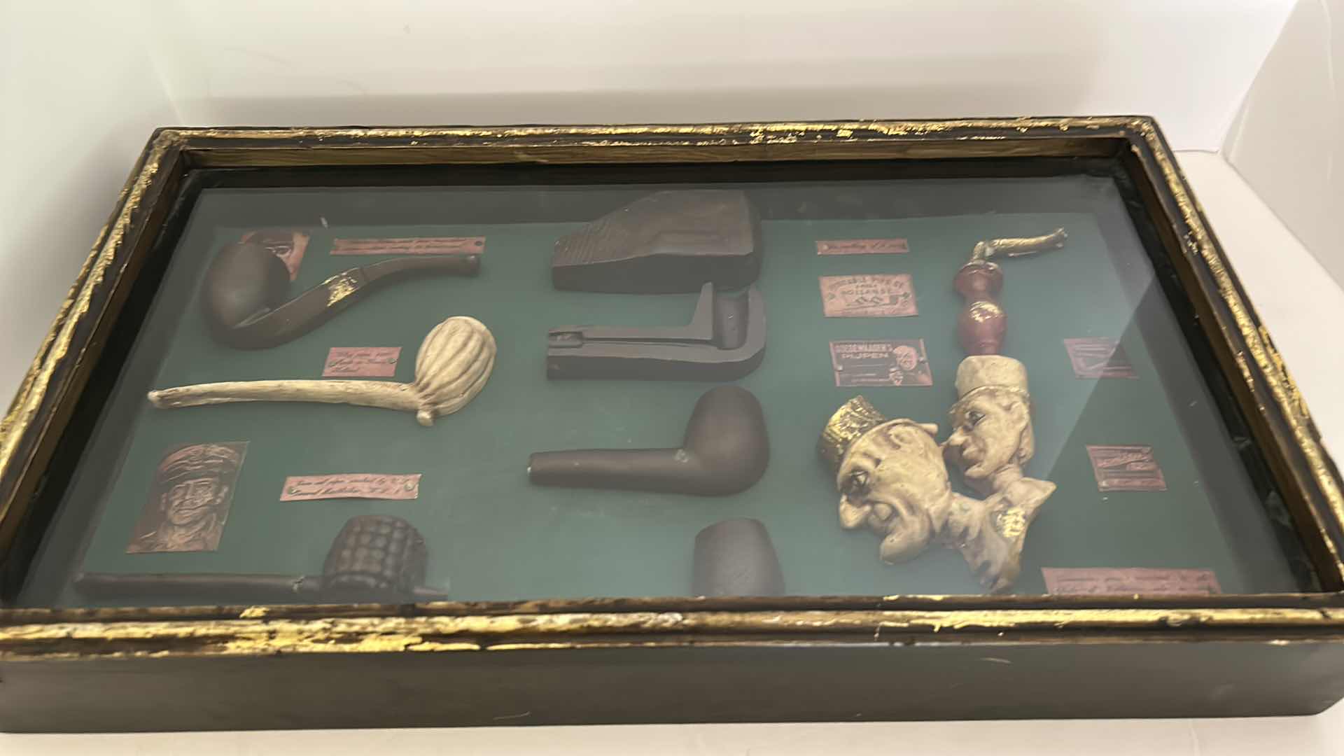 Photo 1 of DISTRESSED BLACK AND GOLD FRAMED SHADOW BOX WITH VINTAGE PIPES 20.5” x 11.25”