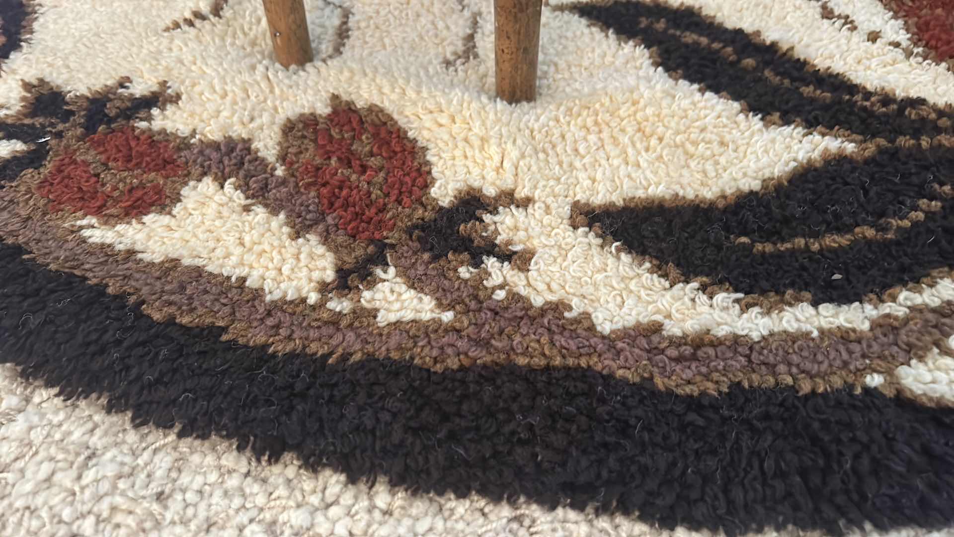 Photo 2 of BROWN AND BLACK AND CREAM 5’ ROUND LOW SHAG CARPET WITH RED FLOWERS