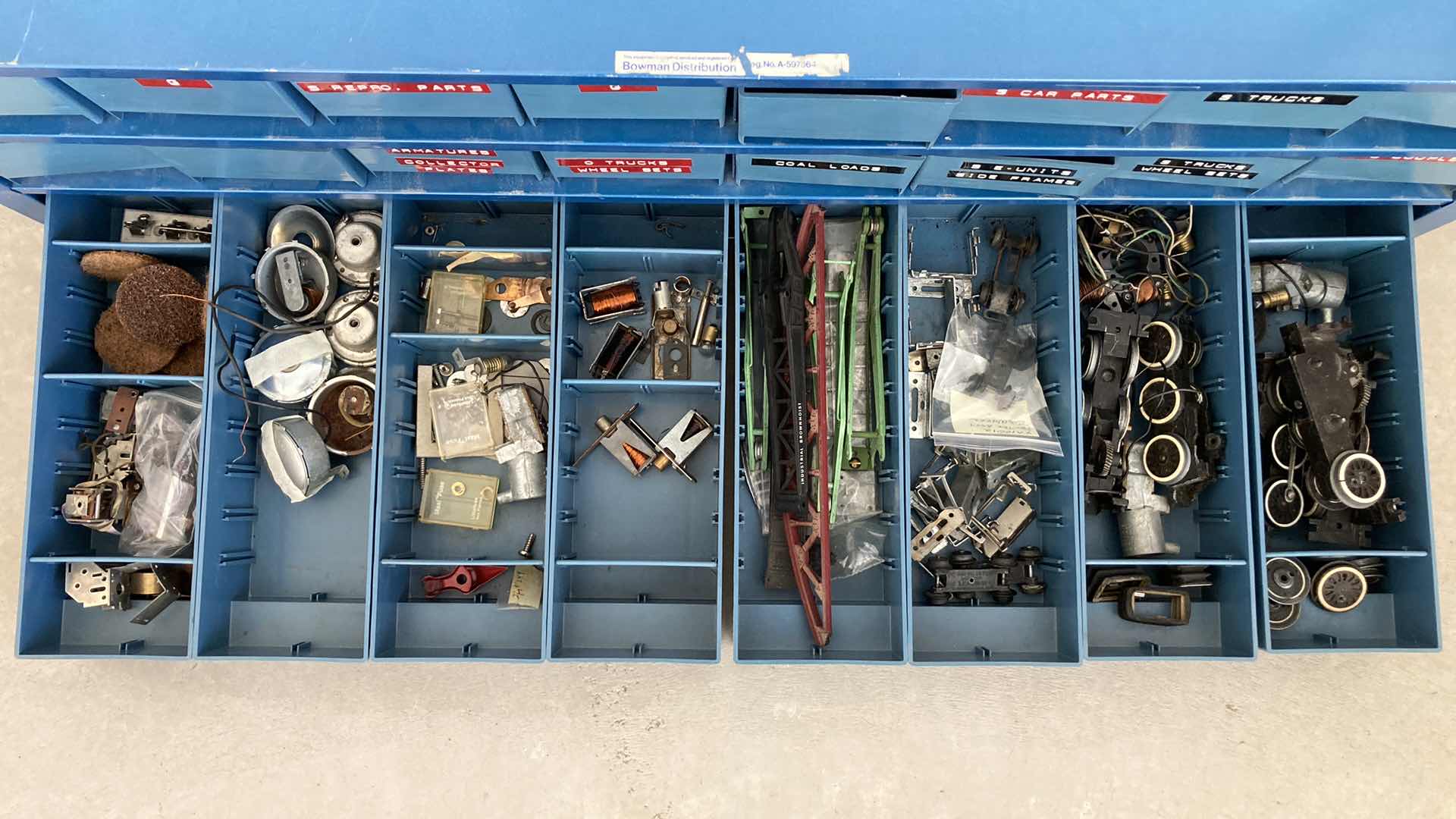 Photo 7 of BOWMAN 24 DRAWER STEEL STORAGE CABINET W MODEL TRAIN PARTS AS LABELED 35” X 12” H10.75”