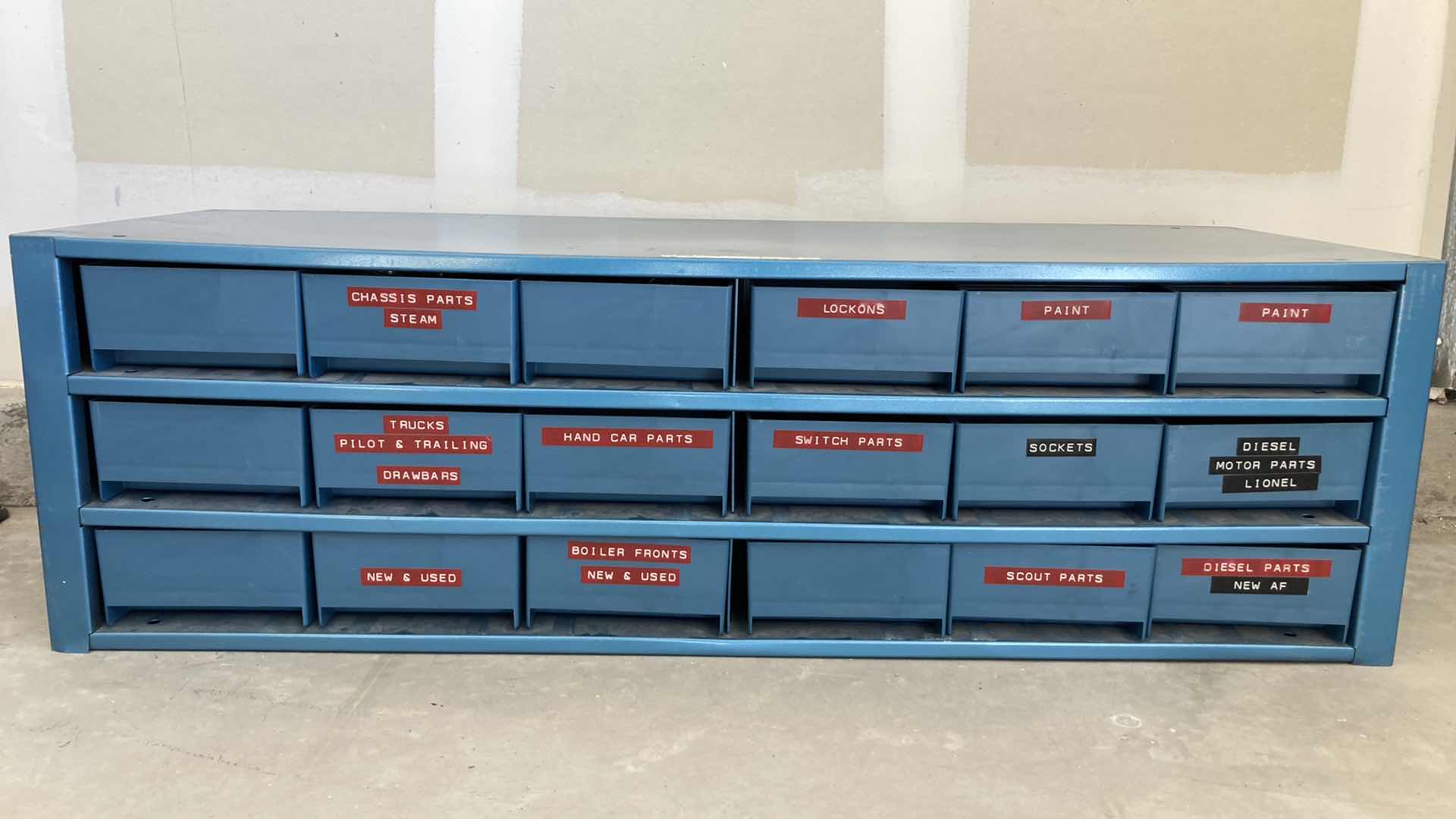 Photo 1 of BOWMAN 18 DRAWER STEEL STORAGE CABINET W MODEL TRAIN PARTS AS LABELED 35” X 12” H10.75”