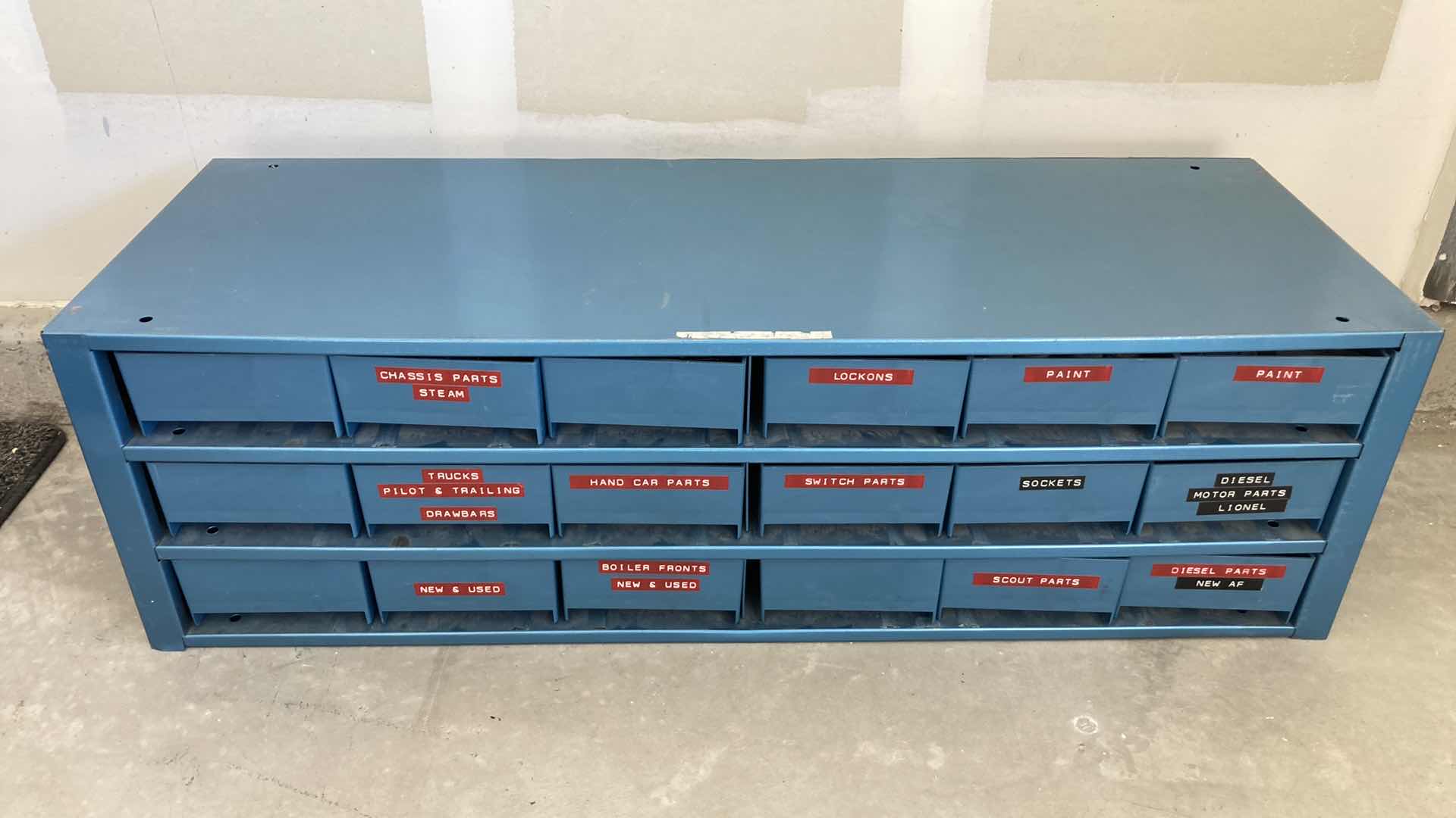 Photo 2 of BOWMAN 18 DRAWER STEEL STORAGE CABINET W MODEL TRAIN PARTS AS LABELED 35” X 12” H10.75”