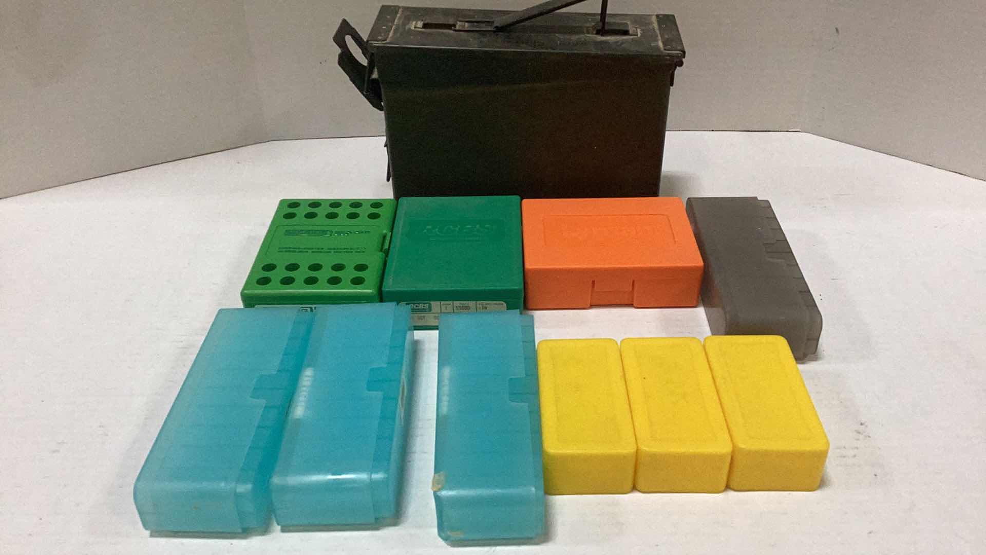 Photo 1 of TEN PLASTIC BULLET CASES AND ONE METAL AMMO CASE