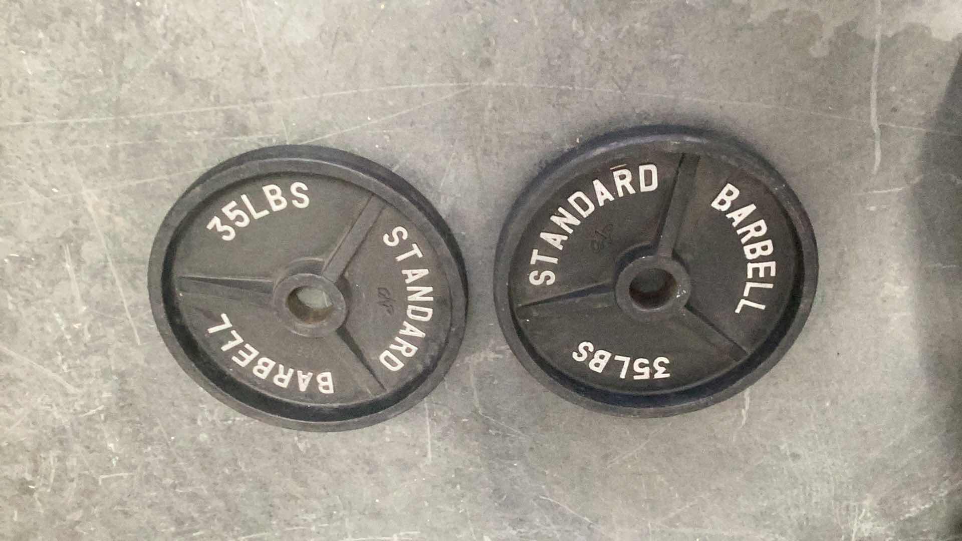 Photo 1 of TWO 35 POUND OLYMPIC BAR WEIGHTS