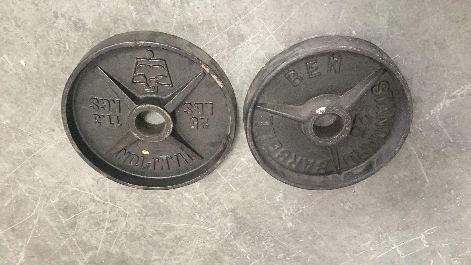 Photo 1 of TWO 25 POUND OLYMPIC BAR WEIGHTS