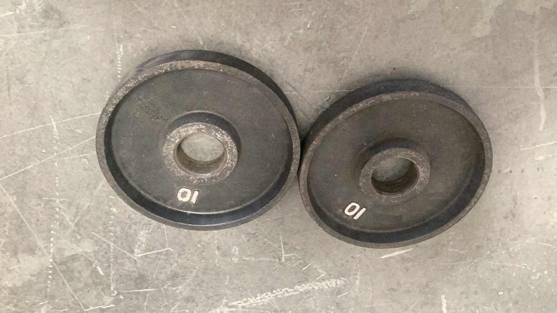 Photo 1 of TWO 10 POUND OLYMPIC BAR WEIGHTS