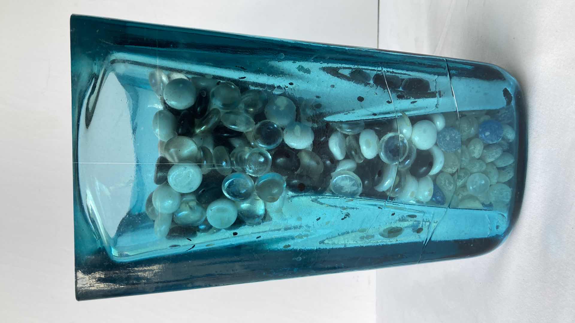 Photo 1 of TEAL CLEAR GLASS VASE W MARBLES 6.5” X 6.5” H11”