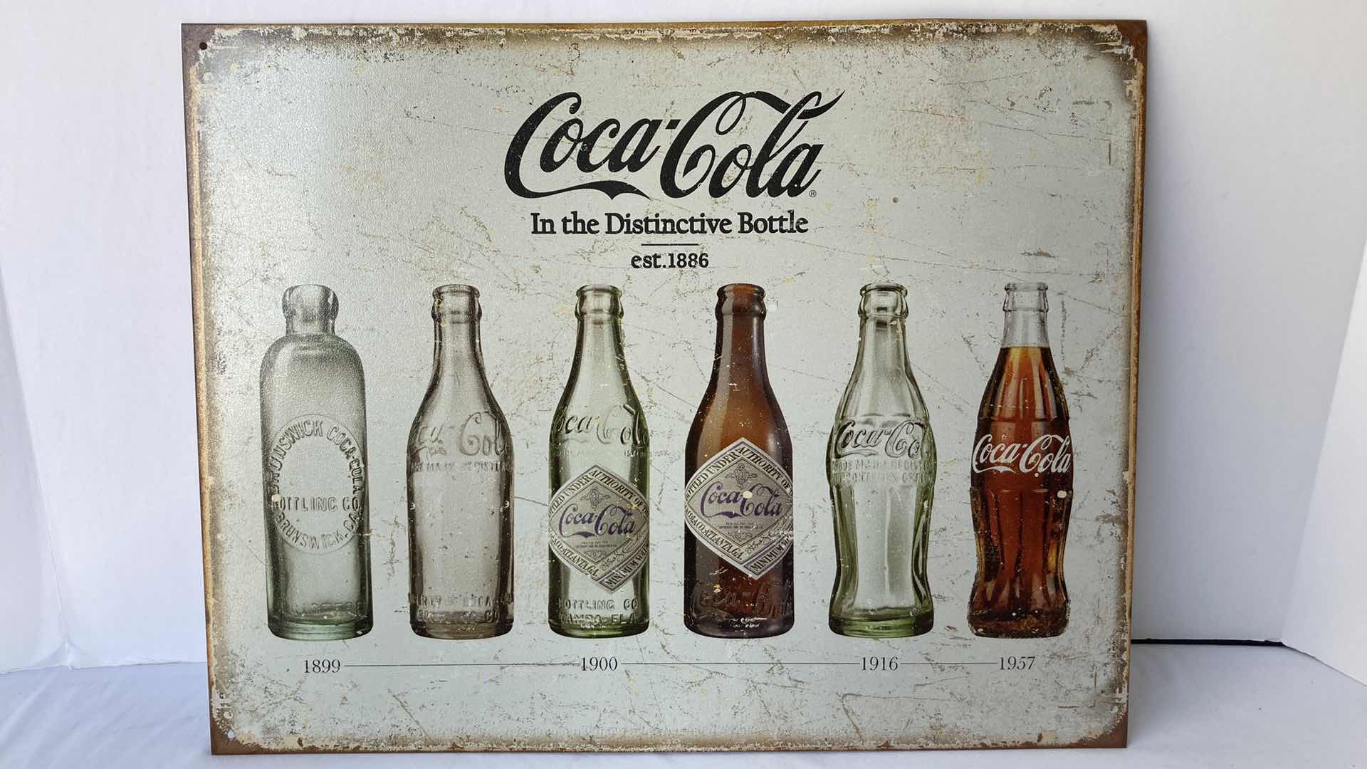 Photo 1 of COCA-COLA BOTTLE REVOLUTION 1899-1957 TIN SIGN 16” X 12.5”