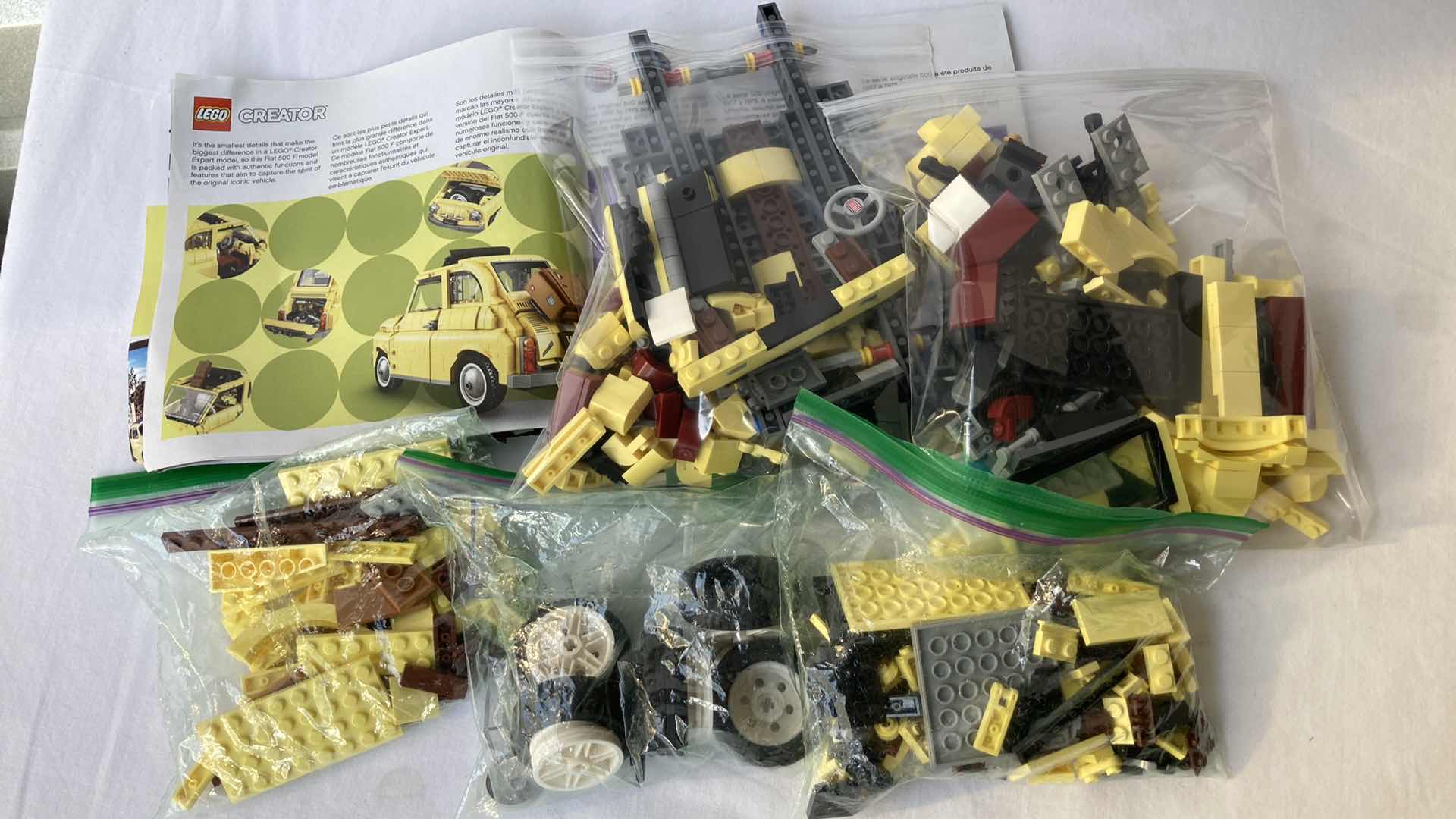Photo 2 of LEGO CREATOR YELLOW FIAT 500 F MODEL & MARVEL SPIDER-MAN 500PC PUZZLE
