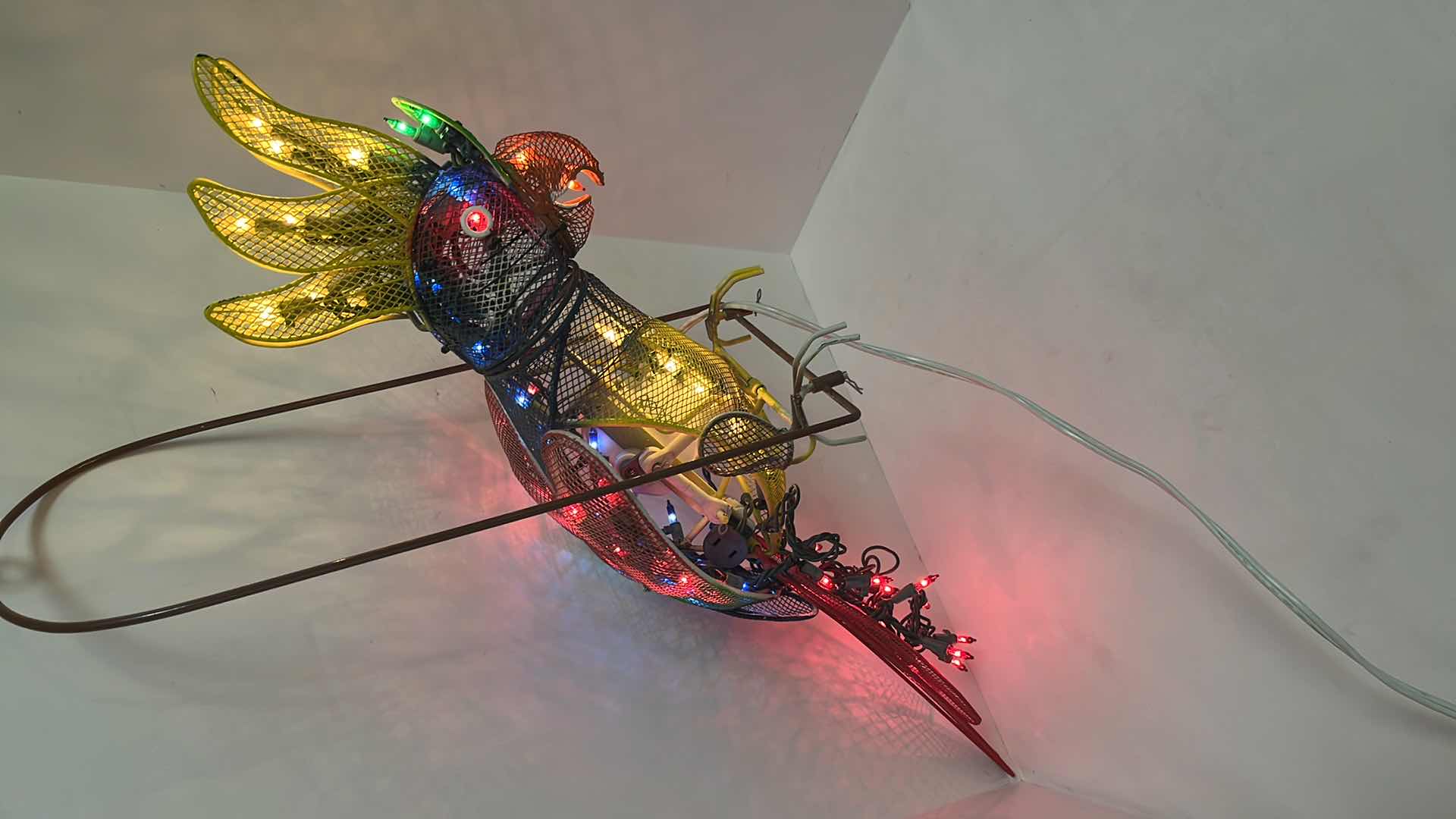 Photo 1 of AUTOMATED LIGHT-UP METAL HANGING PARROT