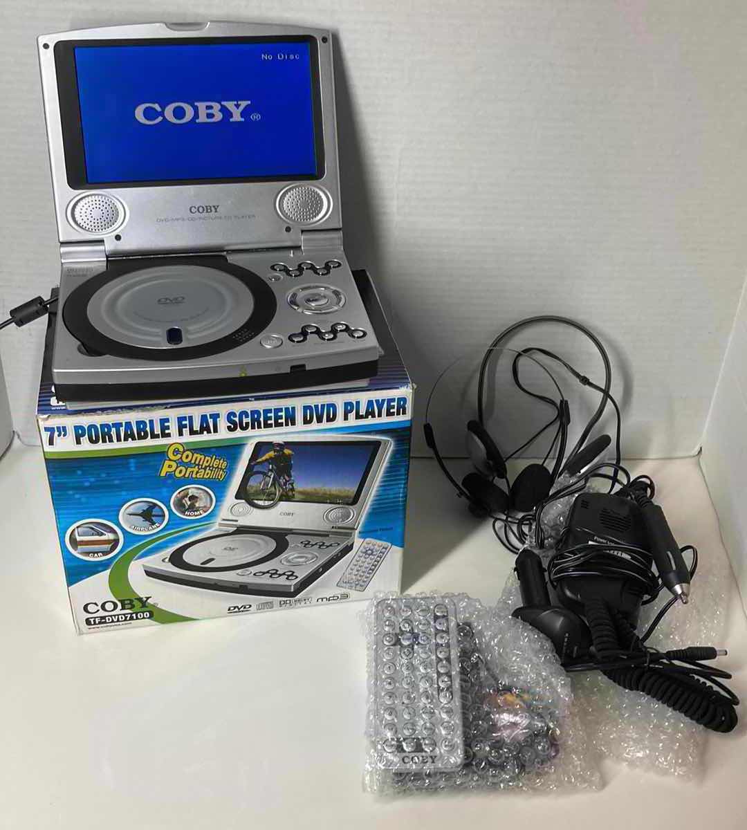 Photo 1 of COBY 7” FLAT SCREEN DVD PLAYER W REMOTE, HOME/CAR POWER CORDS & COMPONENT CABLE