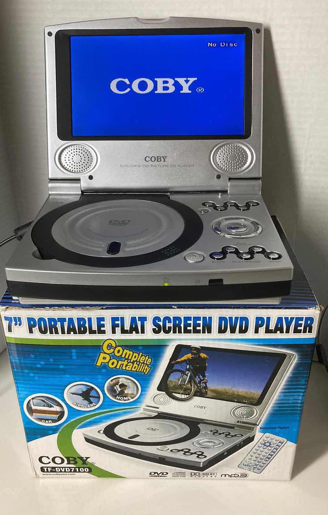 Photo 2 of COBY 7” FLAT SCREEN DVD PLAYER W REMOTE, HOME/CAR POWER CORDS & COMPONENT CABLE