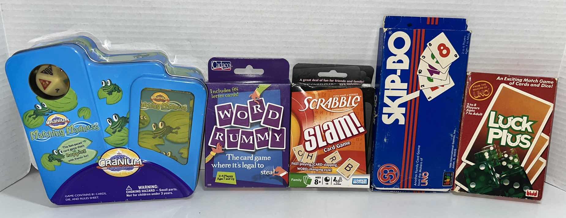 Photo 1 of CRANIUM, WORD RUMMY, SCRABBLE SLAM, SKIP-BO & LUCK PLUS CARD GAMES