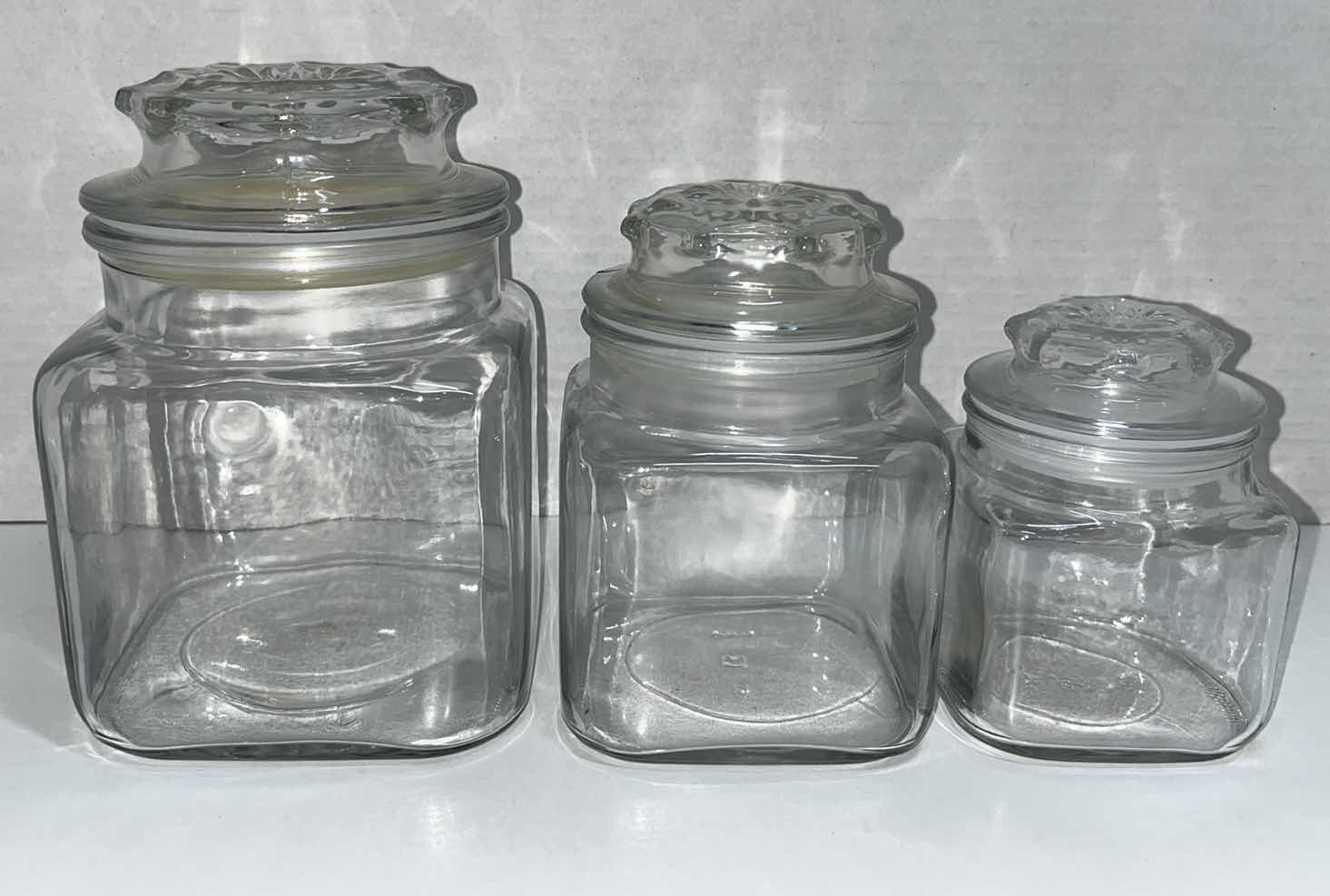 Photo 1 of CLEAR GLASS JAR SET W LIDS (3)