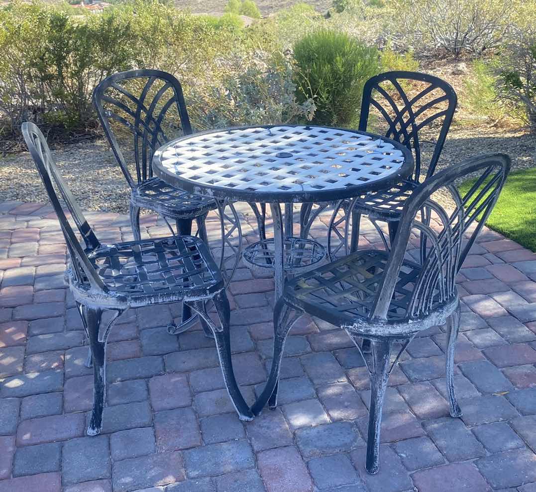 Photo 1 of WROUGHT IRON PATIO TABLE W 4 CHAIRS 35” x 30 1/2”