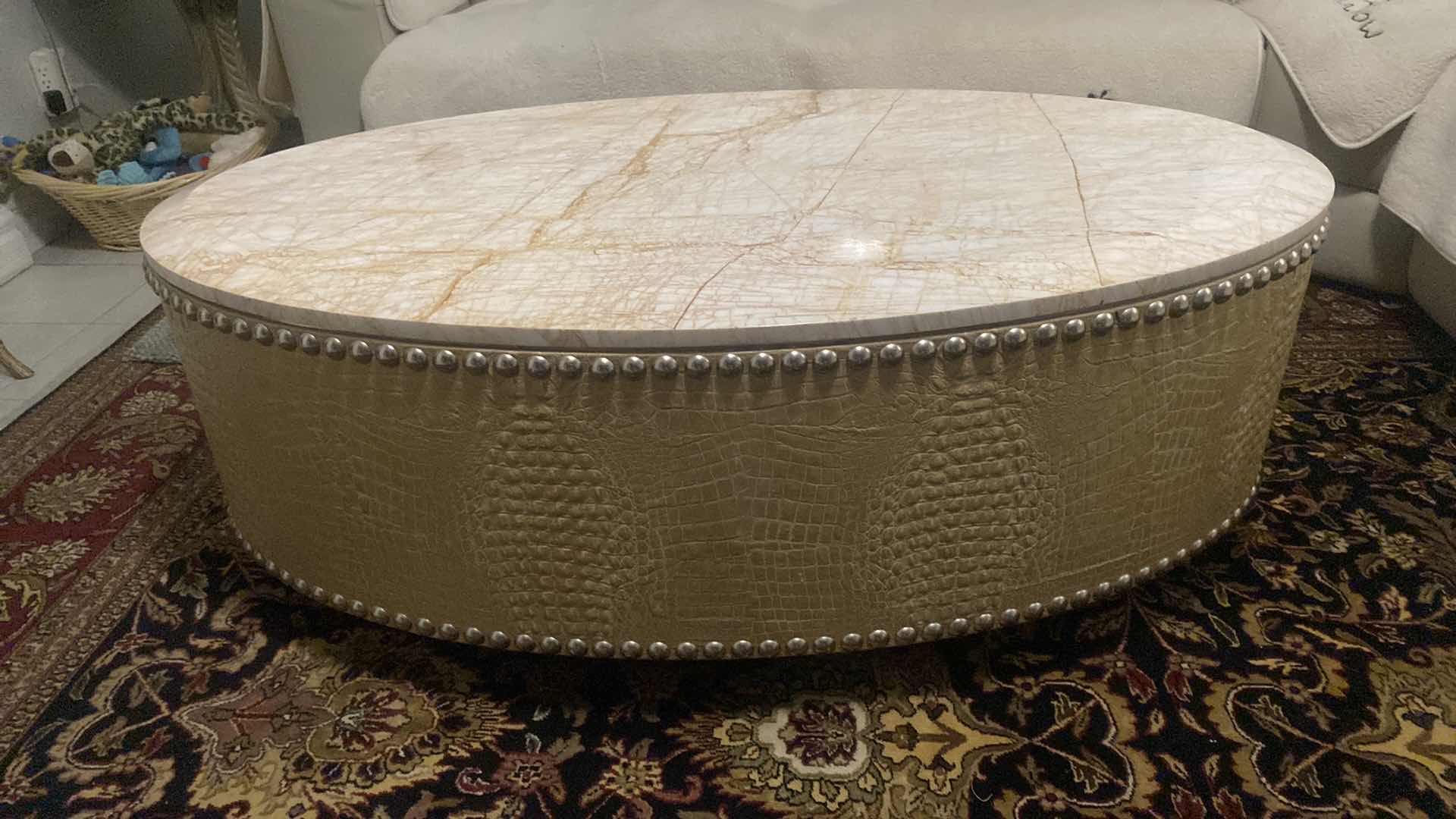 Photo 1 of FAUX CROCODILE AND MARBLE OVAL COCKTAIL TABLE WITH SILVER  STUDS FROM WYNN RESORT 54“ x 30“ H 19 1/2”