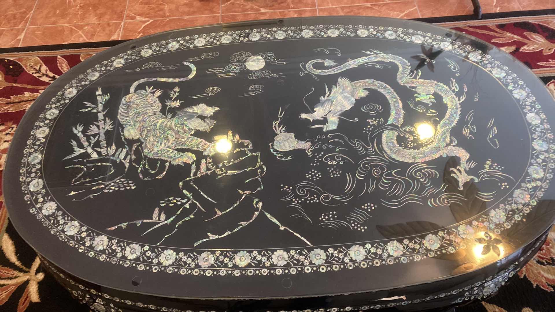 Photo 1 of KOREAN BLACK LACQUER TRADITIONAL COFFEE TABLE WITH MOTHER OF PEARL TIGER  & DRAGON MOTIF 52 1/2“ x 31“ H 18 1/2”