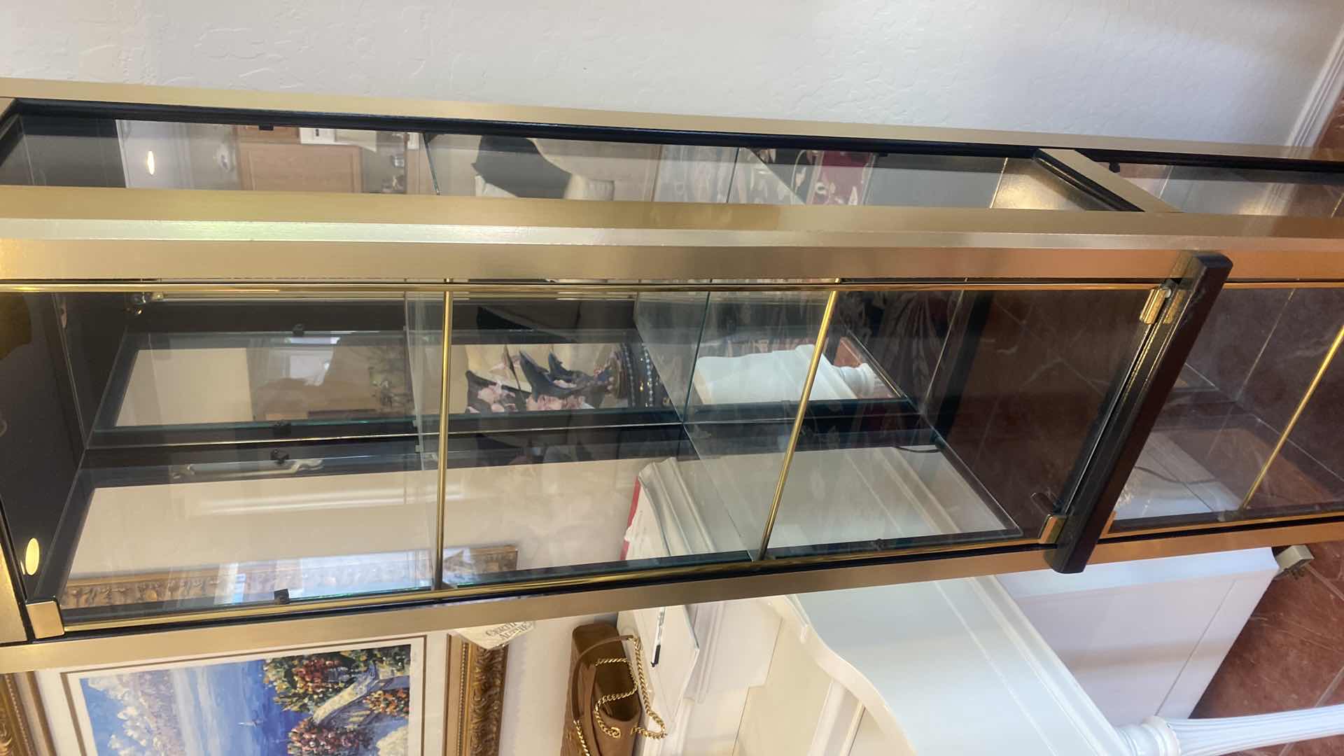 Photo 1 of GOLD & BLACK LIGHTED 2 DOOR DISPLAY CABINET W 3 ADJUSTABLE GLASS SHELVES 18 1/2” x 14” H 72” (two available each sold separately)
