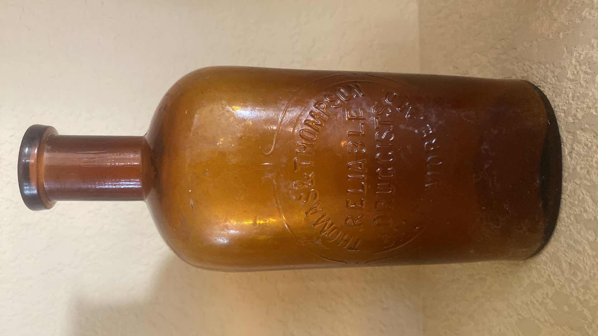 Photo 1 of THOMAS & THOMPSON AMBER GLASS 16oz DRUG STORE BOTTLE WITH 3 SMALL BOTTLED UNMARKED