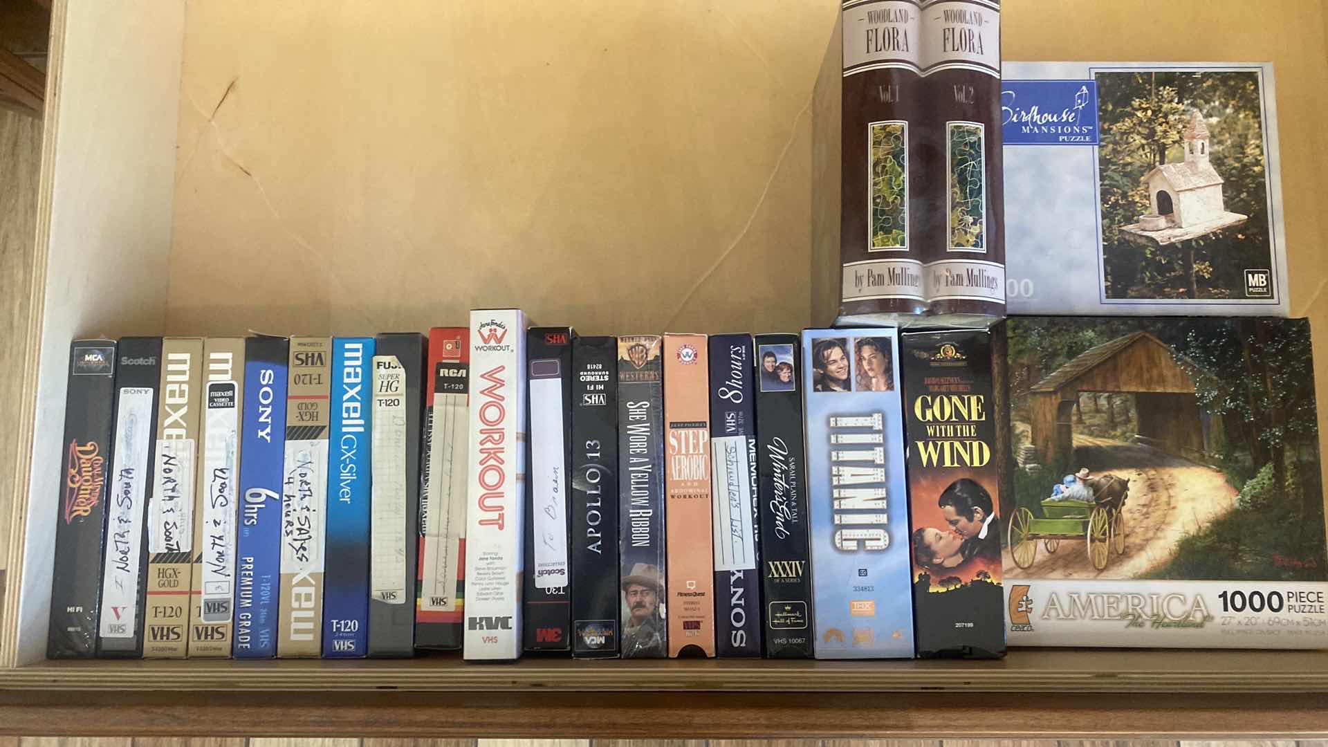 Photo 1 of CONTENTS OF DRAWER, VHS MOVIES, PUZZLES, AND FAUX BOOK DECOR