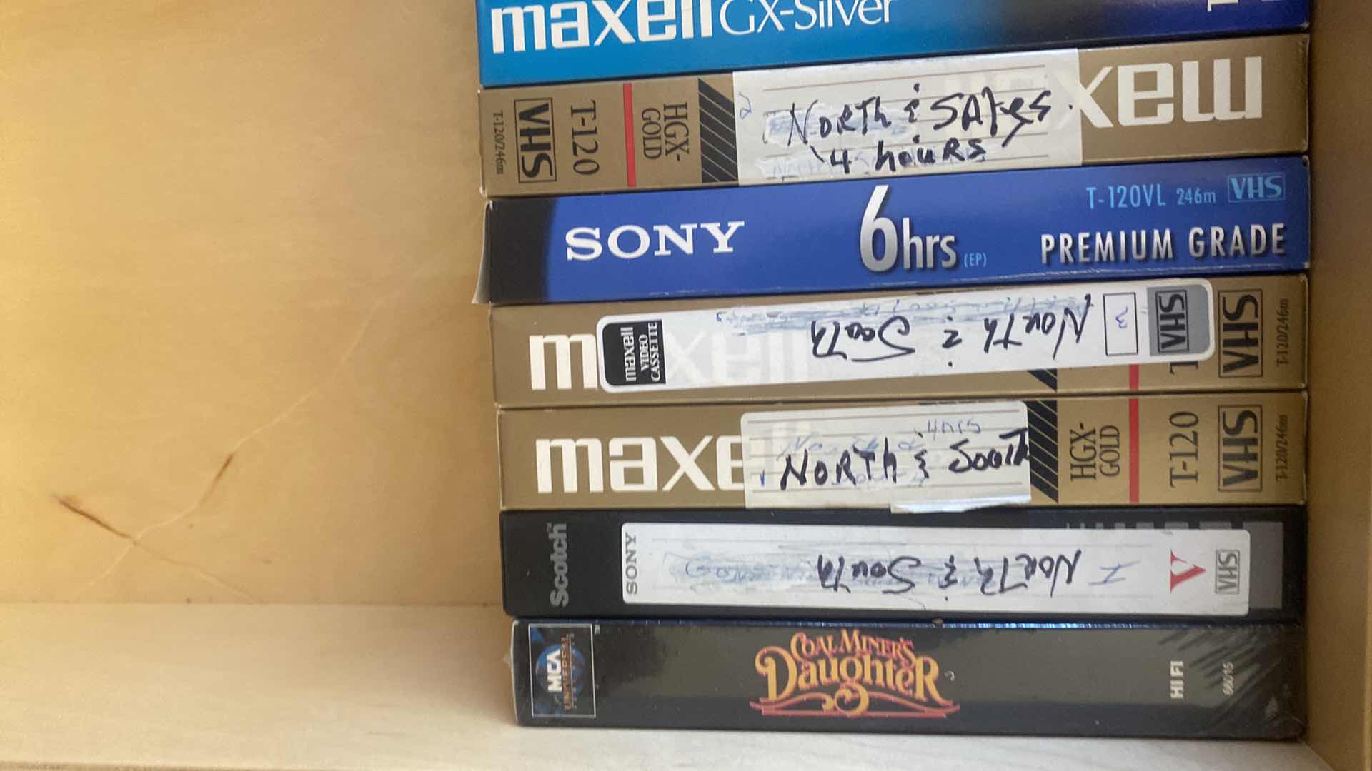 Photo 1 of CONTENTS OF DRAWER, VHS MOVIES, PUZZLES, AND FAUX BOOK DECOR