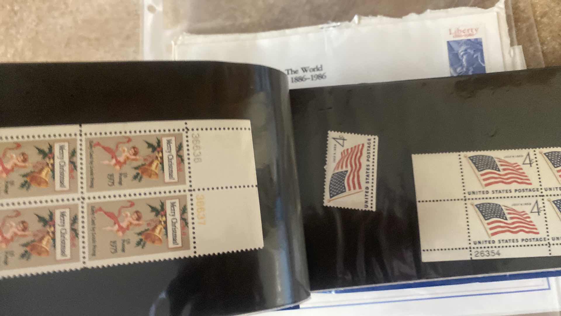 Photo 1 of STAMP COLLECTION ALBUM AND TWO OFFICIAL CENTENNIAL SEAL STATUE OF LIBERTY RESTORATION