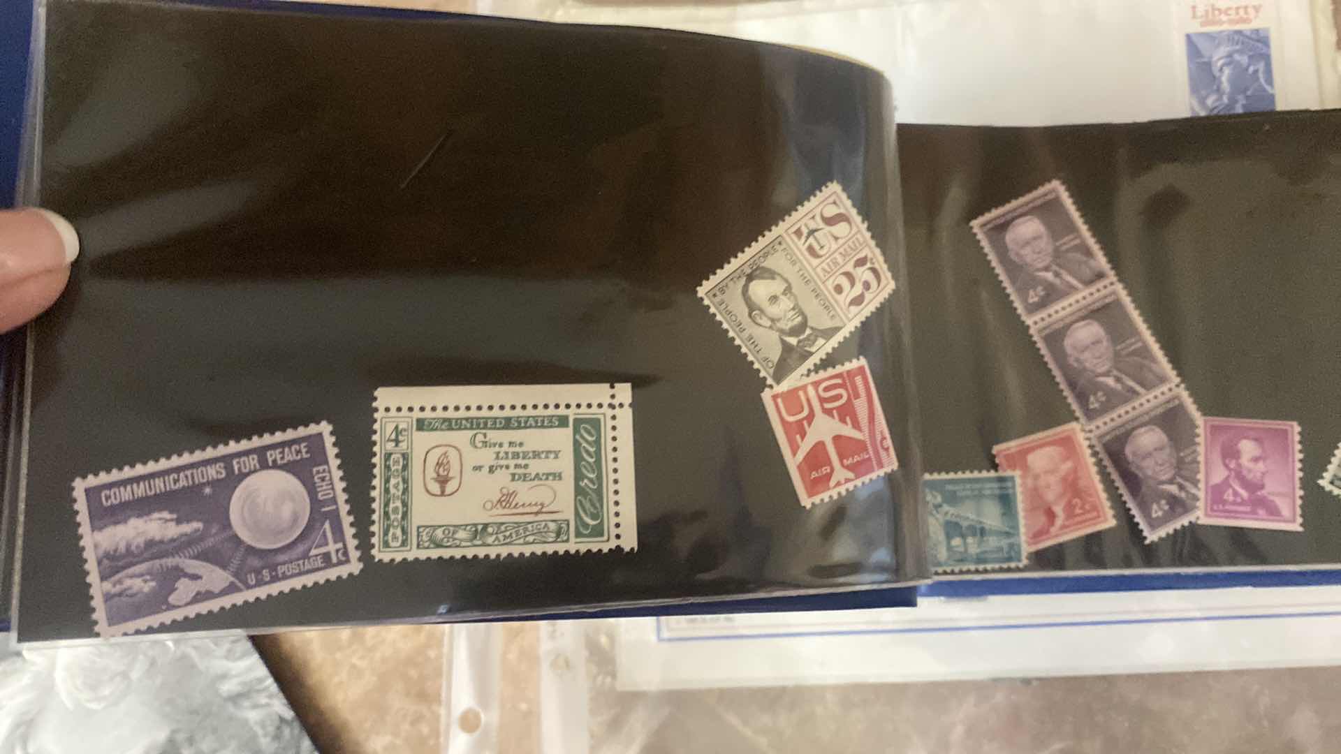 Photo 1 of STAMP COLLECTION ALBUM AND TWO OFFICIAL CENTENNIAL SEAL STATUE OF LIBERTY RESTORATION