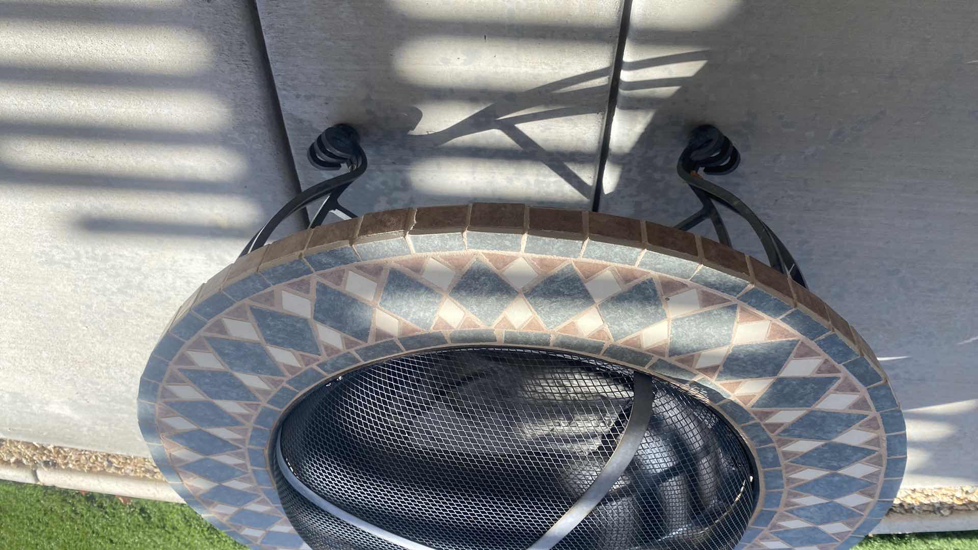 Photo 1 of 34” ROUND FIRE PIT WITH TILE TRIM AND HEAVY CAST METAL BASE)