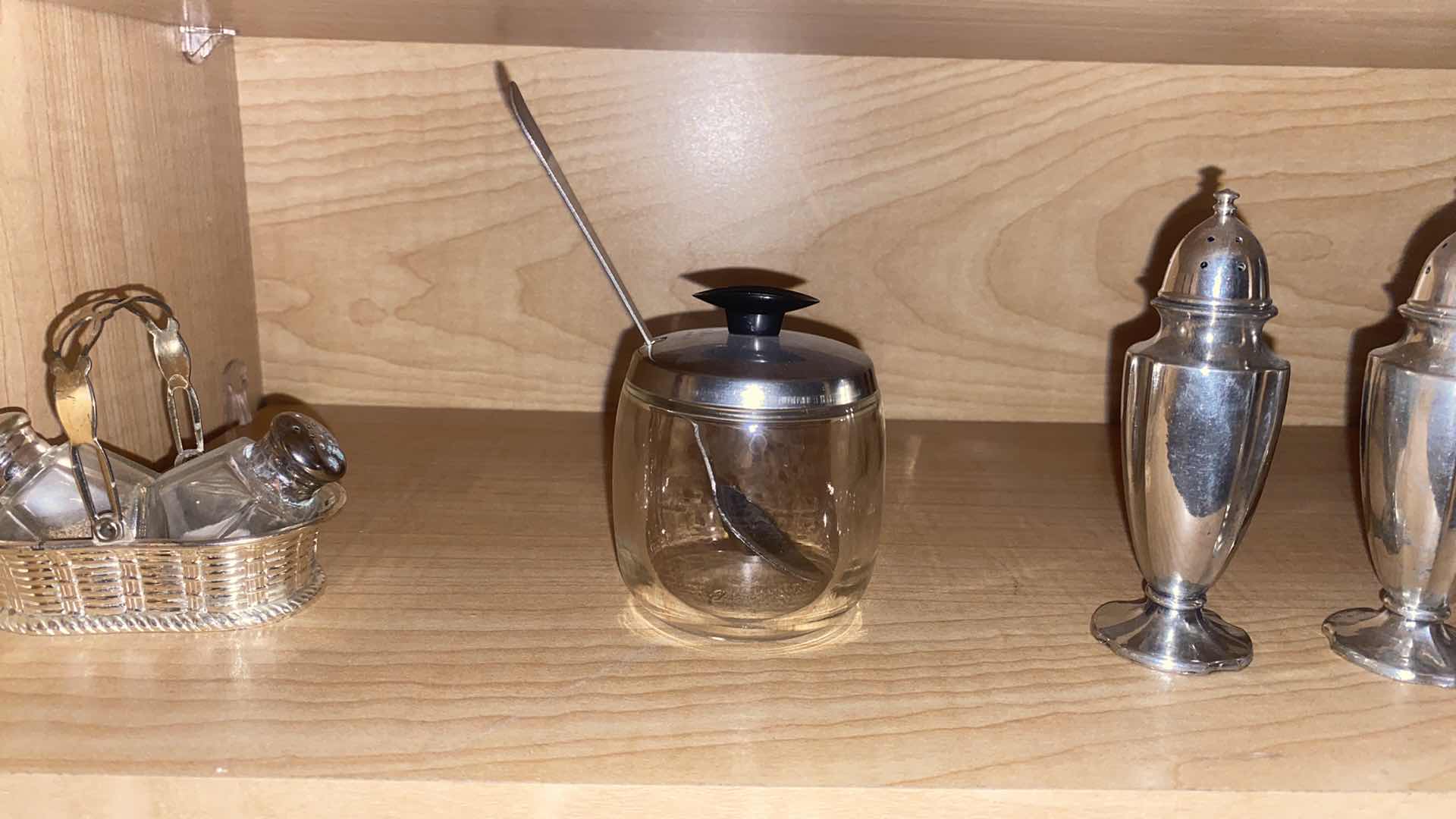Photo 1 of CONTENTS OF CABINET SILVER PLATED CANDLE HOLDERS SALT & PEPPER & WATER PITCHER