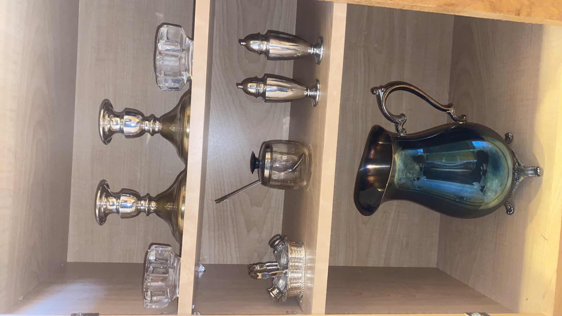 Photo 1 of CONTENTS OF CABINET SILVER PLATED CANDLE HOLDERS SALT & PEPPER & WATER PITCHER