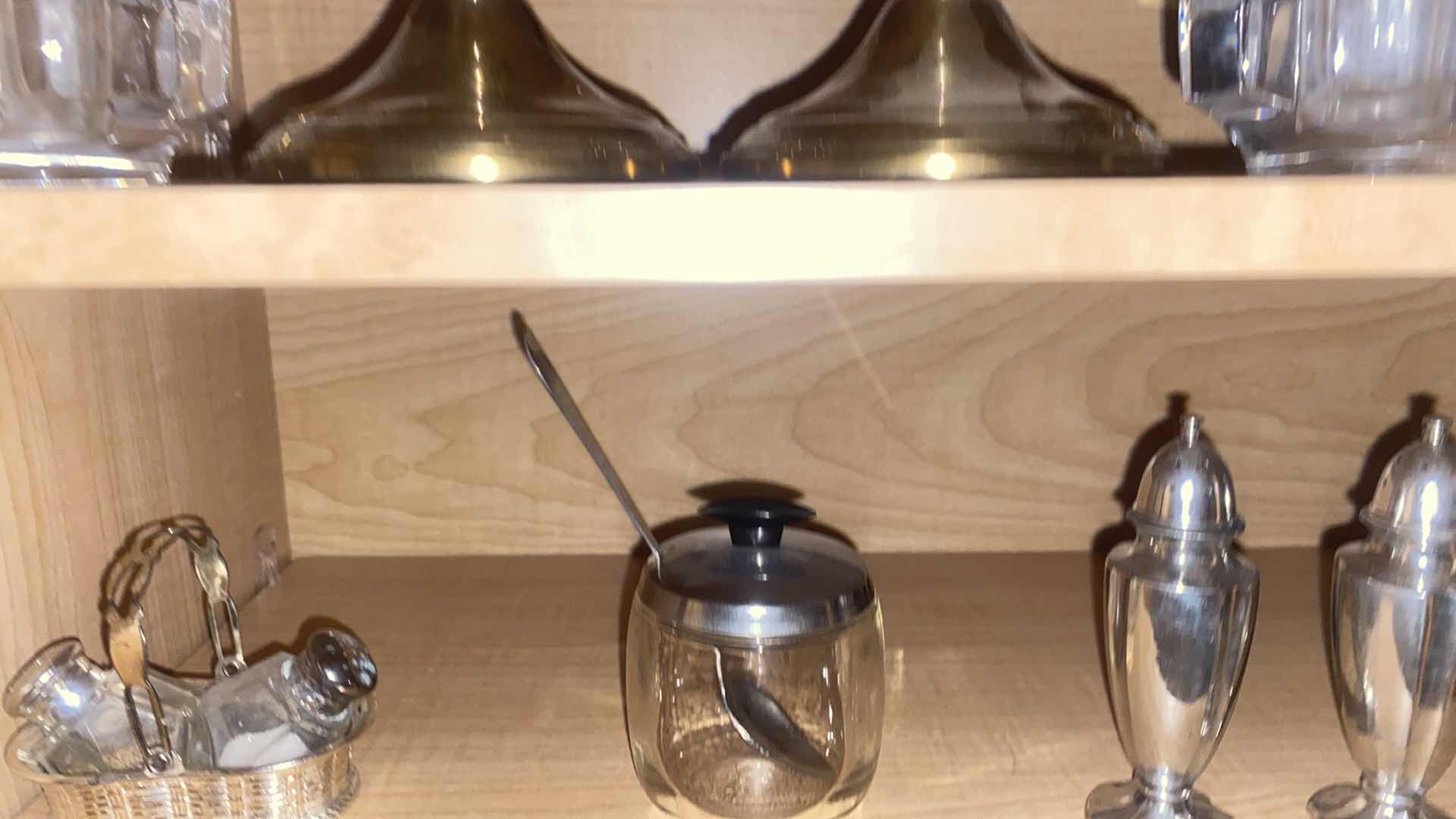 Photo 1 of CONTENTS OF CABINET SILVER PLATED CANDLE HOLDERS SALT & PEPPER & WATER PITCHER