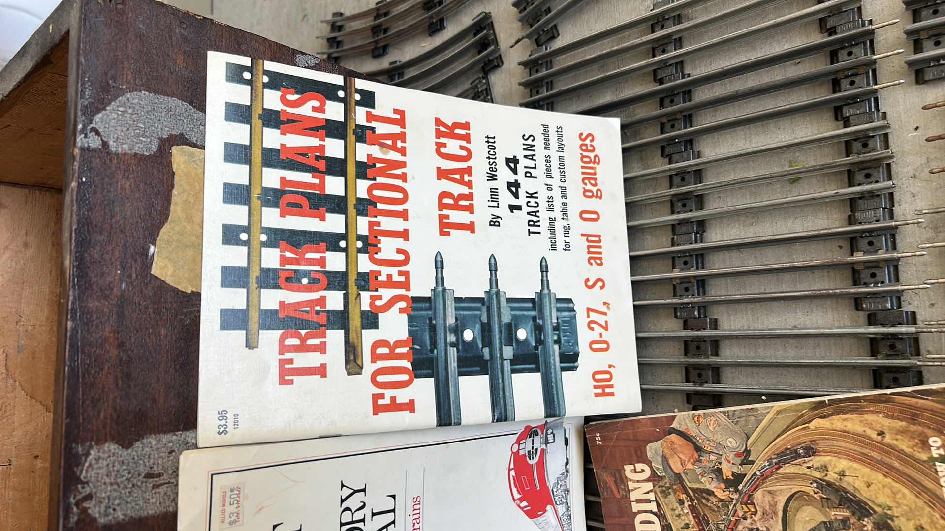 Photo 1 of LIONEL TRAIN TRACKS & MORE - 32 STRAIGHT, 22 CURVED, CONTROL SWITCHES, LAYOUT GUIDE, VINTAGE MODEL RAILROAD MAGAZINE & MANUALS WITH VINTAGE TRUNK