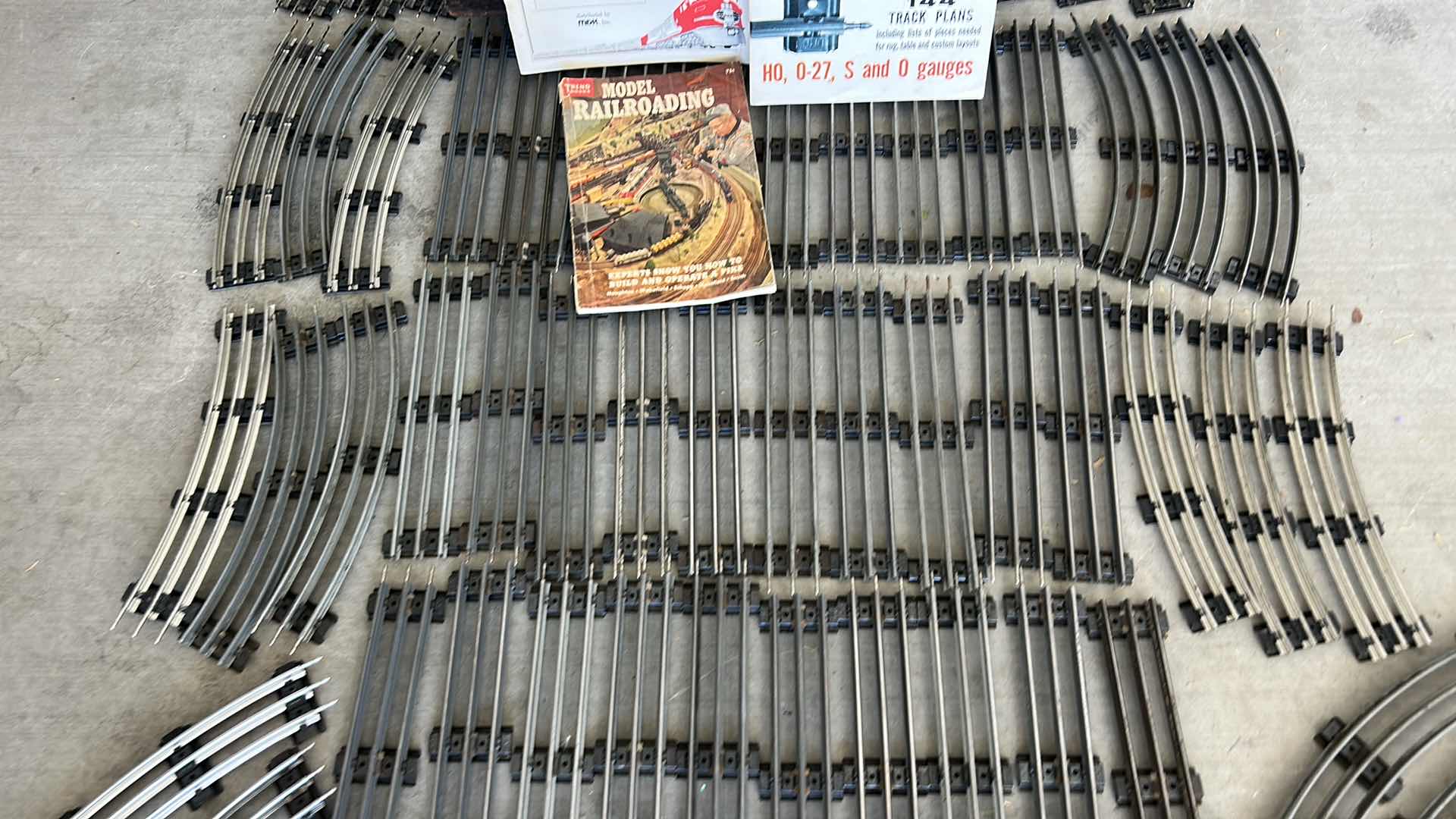 Photo 1 of LIONEL TRAIN TRACKS & MORE - 32 STRAIGHT, 22 CURVED, CONTROL SWITCHES, LAYOUT GUIDE, VINTAGE MODEL RAILROAD MAGAZINE & MANUALS WITH VINTAGE TRUNK