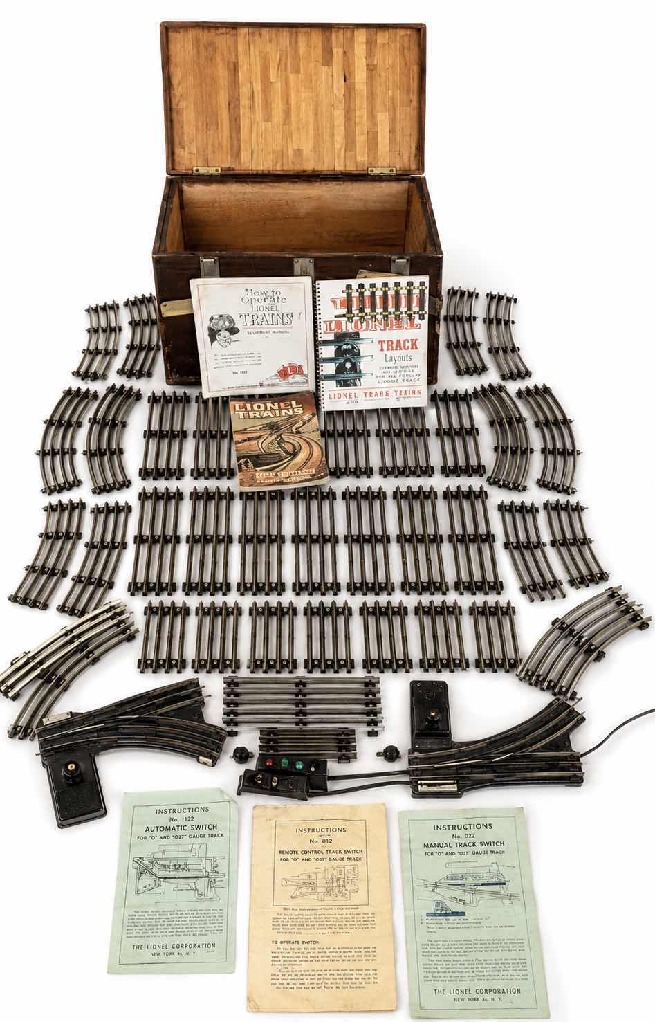 Photo 1 of LIONEL TRAIN TRACKS & MORE - 32 STRAIGHT, 22 CURVED, CONTROL SWITCHES, LAYOUT GUIDE, VINTAGE MODEL RAILROAD MAGAZINE & MANUALS WITH VINTAGE TRUNK