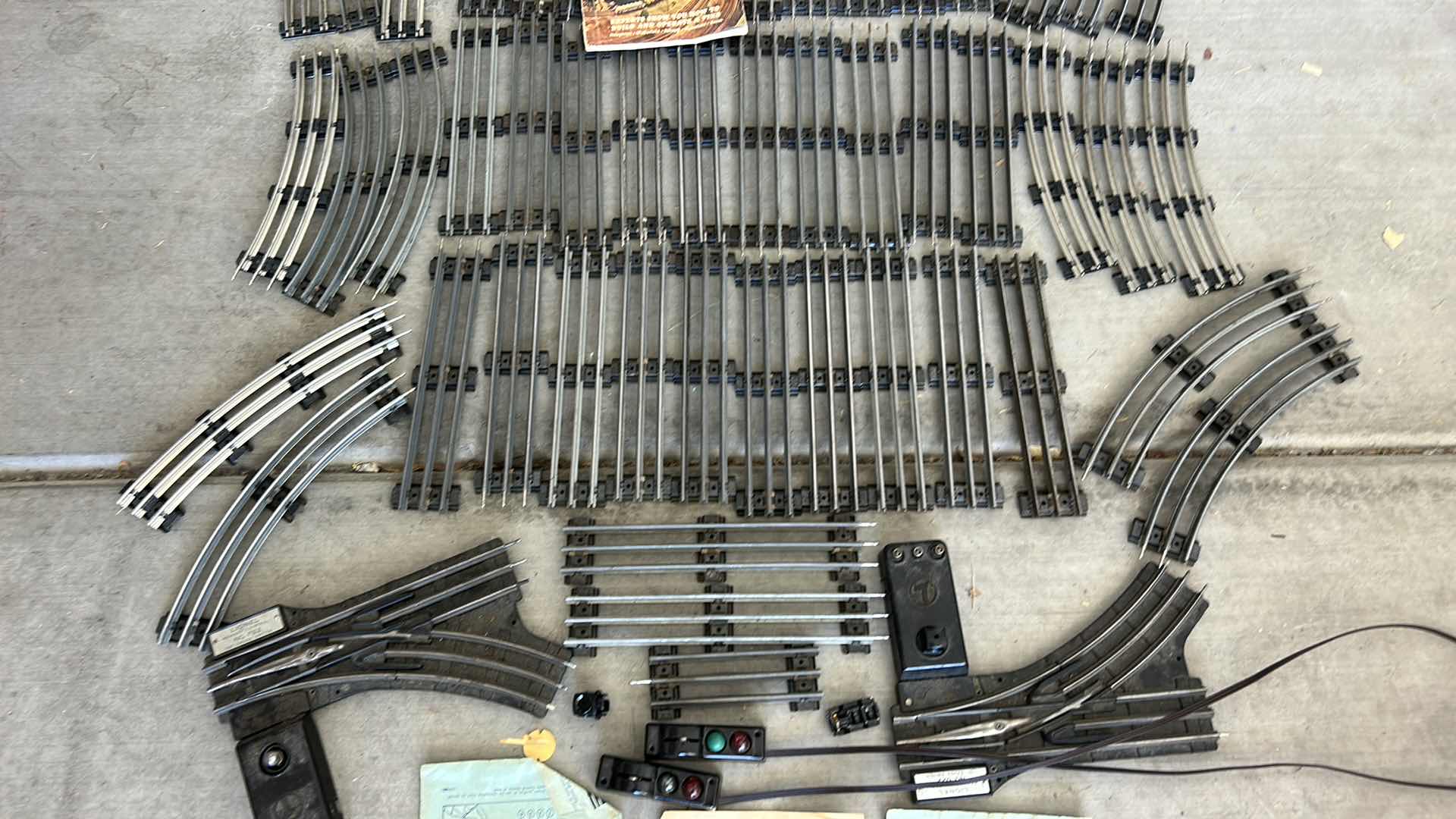 Photo 1 of LIONEL TRAIN TRACKS & MORE - 32 STRAIGHT, 22 CURVED, CONTROL SWITCHES, LAYOUT GUIDE, VINTAGE MODEL RAILROAD MAGAZINE & MANUALS WITH VINTAGE TRUNK