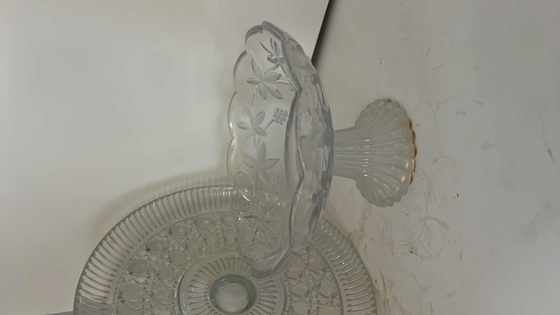 Photo 1 of ASSORTED VINTAGE CLEAR PRESSED GLASS SERVING PIECES INCLUDING DECORATIVE ROUND PLATTER, PEDESTAL COMPOTE AND FLORAL RELIEF DISH.
ESTIMATED RETAIL VALUE: $40–$60 FOR THE GROUP.