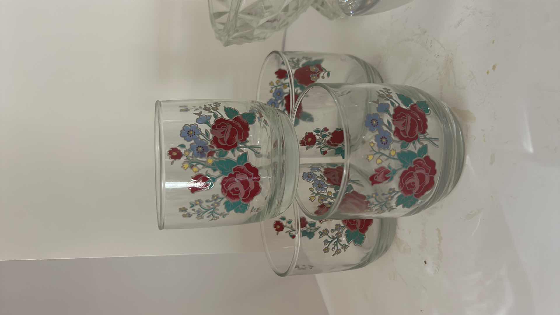 Photo 1 of ASSORTED VINTAGE GLASSWARE INCLUDING 4 FLORAL TUMBLERS, CLEAR PRESSED GLASS BOWLS AND GREEN ART GLASS DISH.