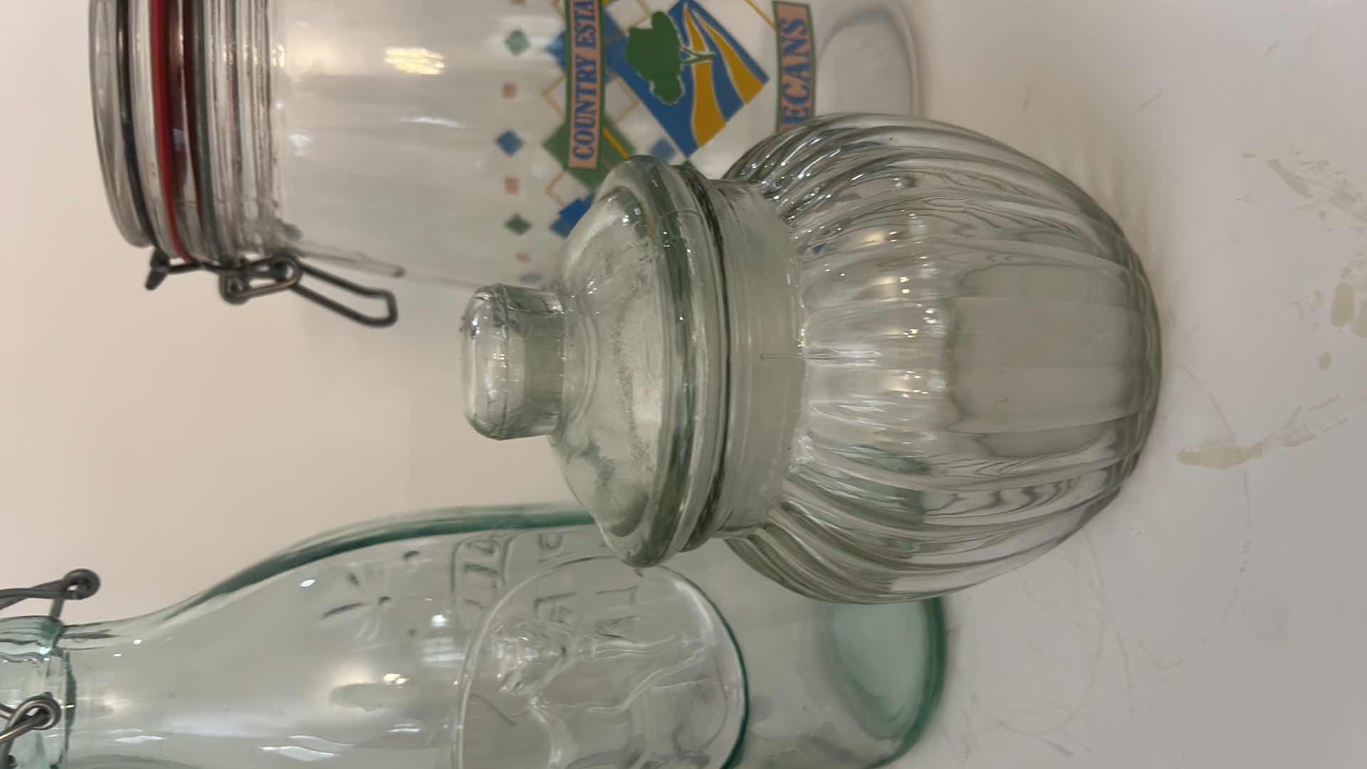 Photo 1 of ASSORTED CLEAR GLASS KITCHEN STORAGE JARS, CANISTERS & BOTTLE WITH CORK, GLASS AND CLAMP-TOP LIDS