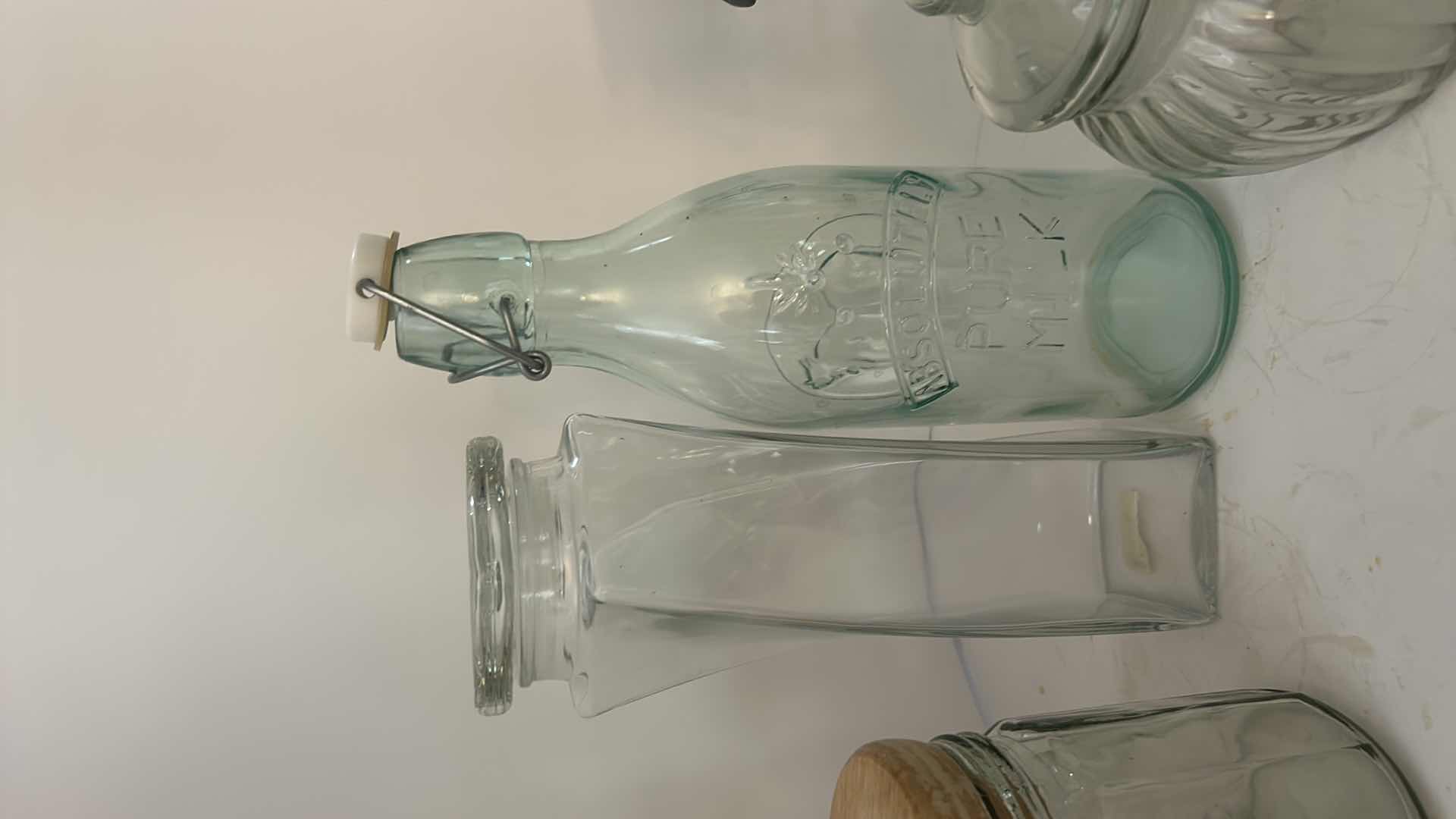 Photo 1 of ASSORTED CLEAR GLASS KITCHEN STORAGE JARS, CANISTERS & BOTTLE WITH CORK, GLASS AND CLAMP-TOP LIDS