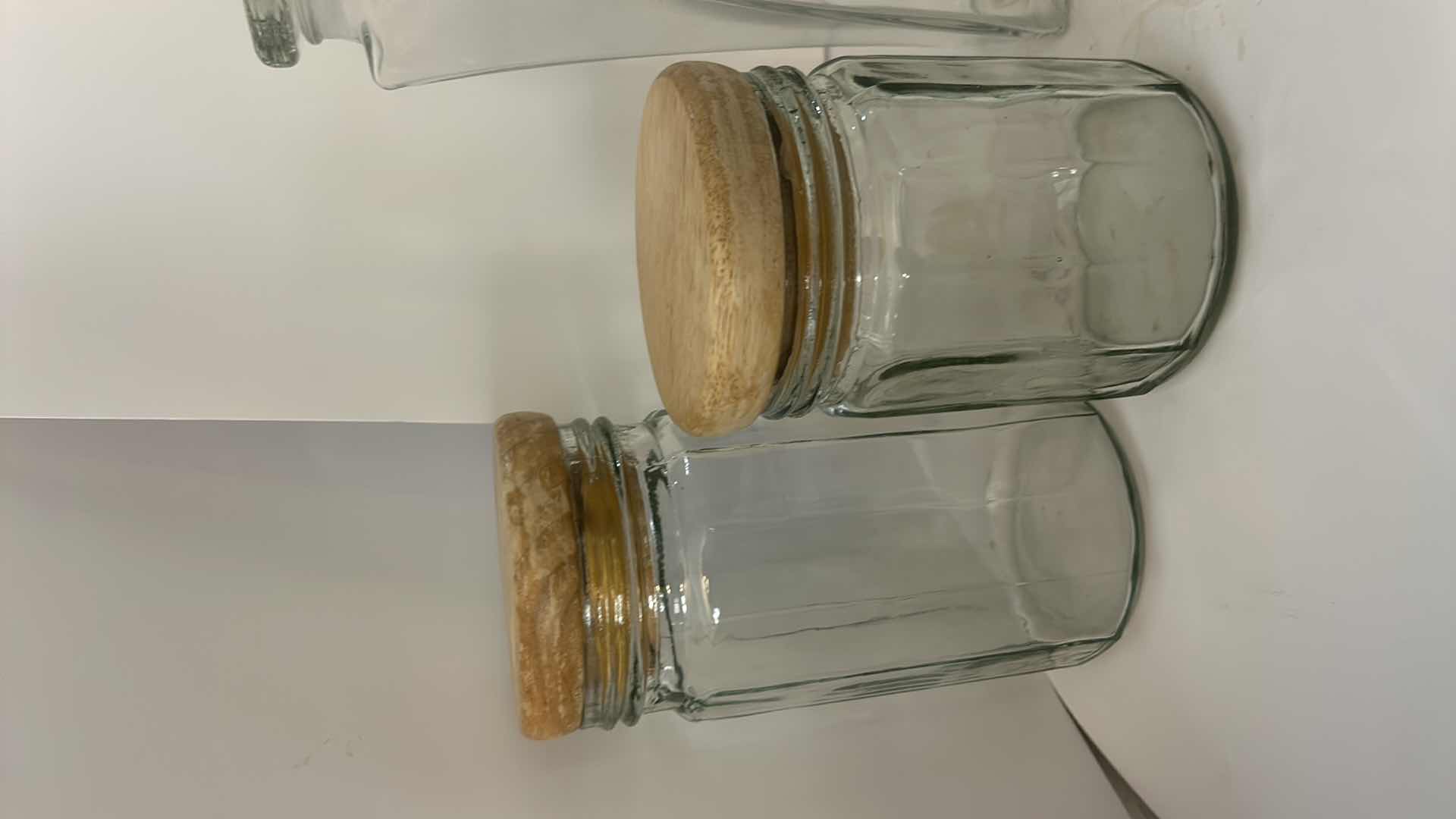 Photo 1 of ASSORTED CLEAR GLASS KITCHEN STORAGE JARS, CANISTERS & BOTTLE WITH CORK, GLASS AND CLAMP-TOP LIDS